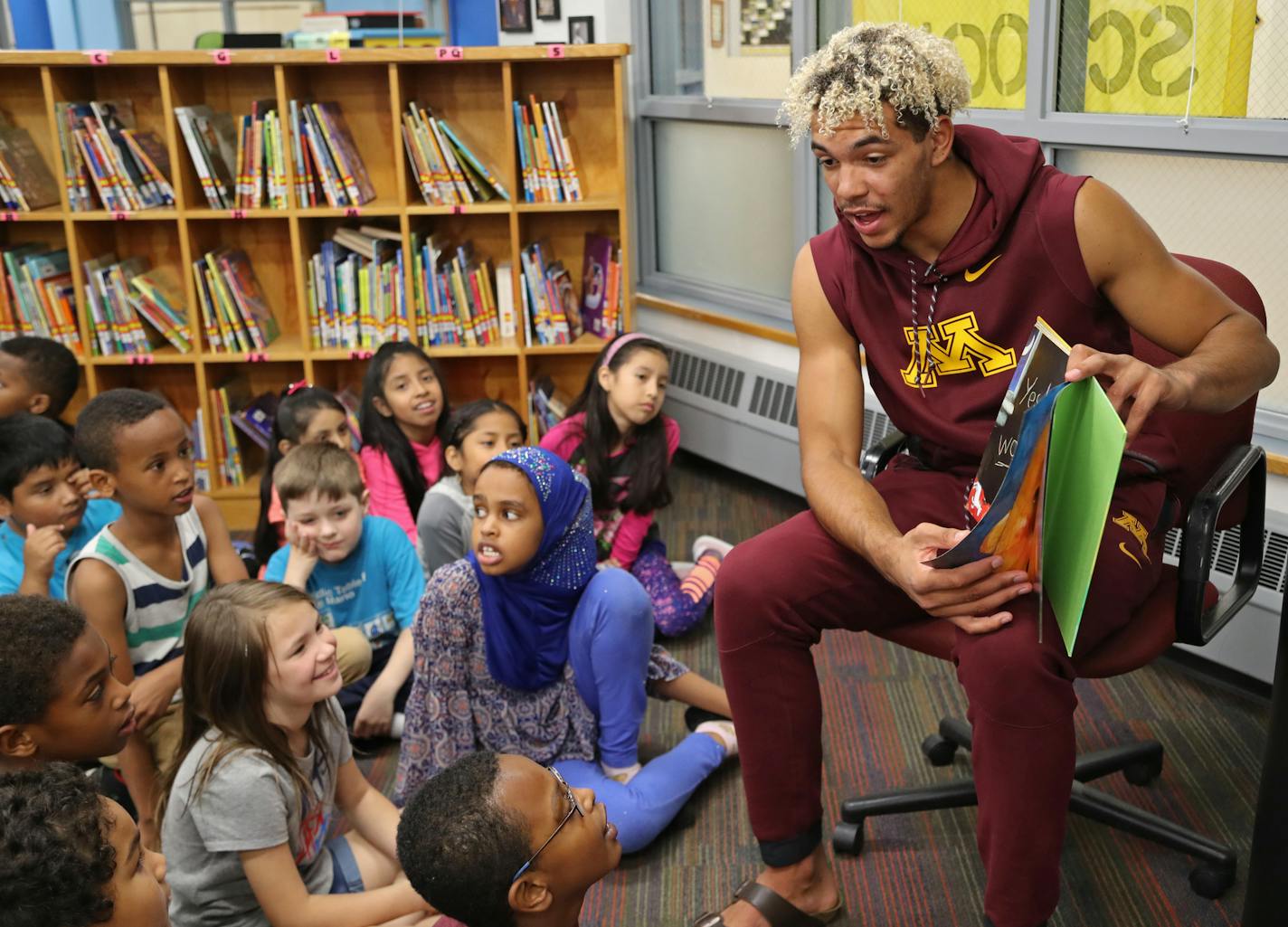 Gophers basketball player Jarvis Omersa read to third-graders at Pillsbury Elementary in Minneapolis on Friday, kicking off the "Read to the Final Four" activities.