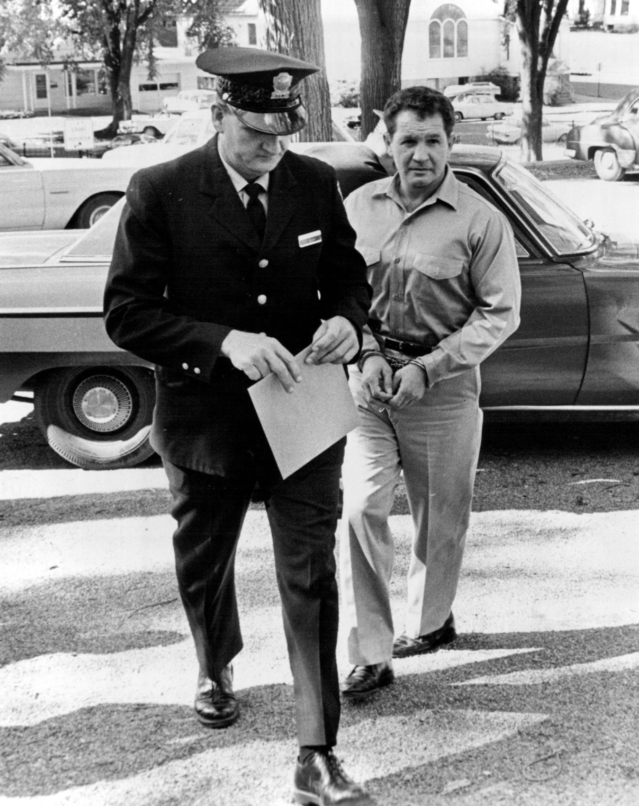 October 6, 1966 Back in Court - Norman J. Mastrian, shown above as he arrived with a prison officer, appeared Wednesday before Judge Robert B. Gil­lespie of the Washington County District Court. He con­tends his constitutional rights were violated because Ramsey County authorities failed to furnish him with a transcript of his trial. Mastrian was convicted as the alleged middleman in the 1963 murder Mrs. T. Eugene Thompson, wire of a St. Paul lawyer. His attorneys, John Cochrane and Douglas W. T