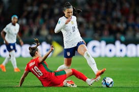 Portugal's Diana Gomes, left, tackles United States' Sophia Smith during the Women's World Cup Group E soccer match between Portugal and the United St