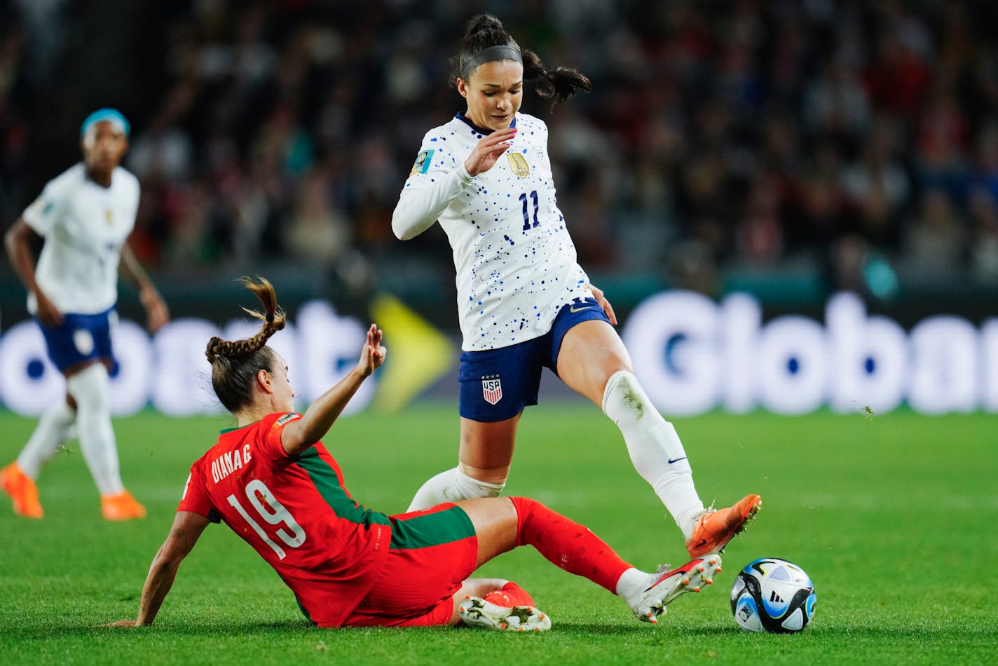 Portugal's Diana Gomes, left, tackles United States' Sophia Smith during the Women's World Cup Group E soccer match between Portugal and the United States at Eden Park in Auckland, New Zealand, Tuesday, Aug. 1, 2023. (AP Photo/Abbie Parr)