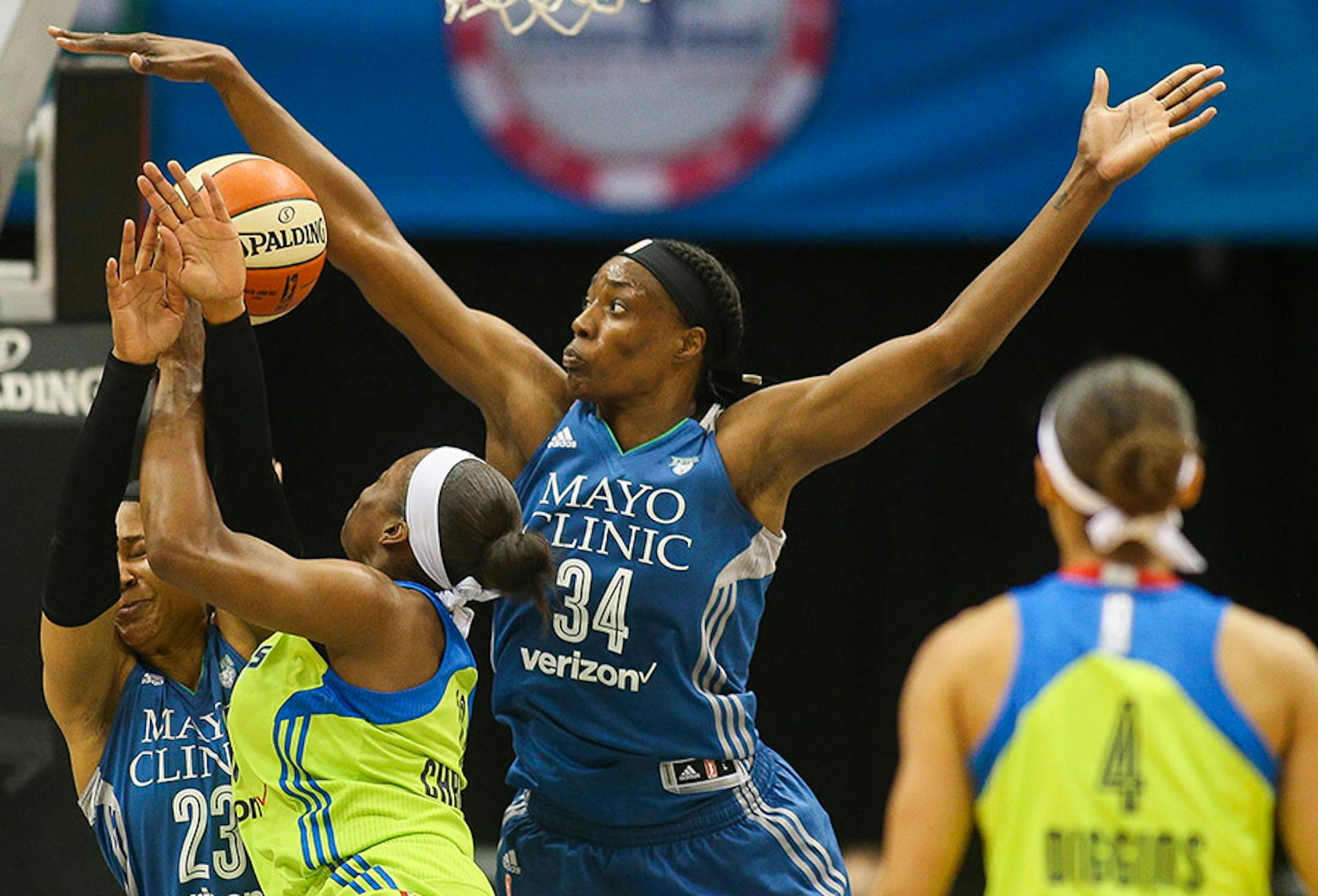 Minnesota Lynx center Sylvia Fowles (34) gets a piece of the ball as Dallas Wings forward Karima Christmas (13) drives to the basket during a game in June.