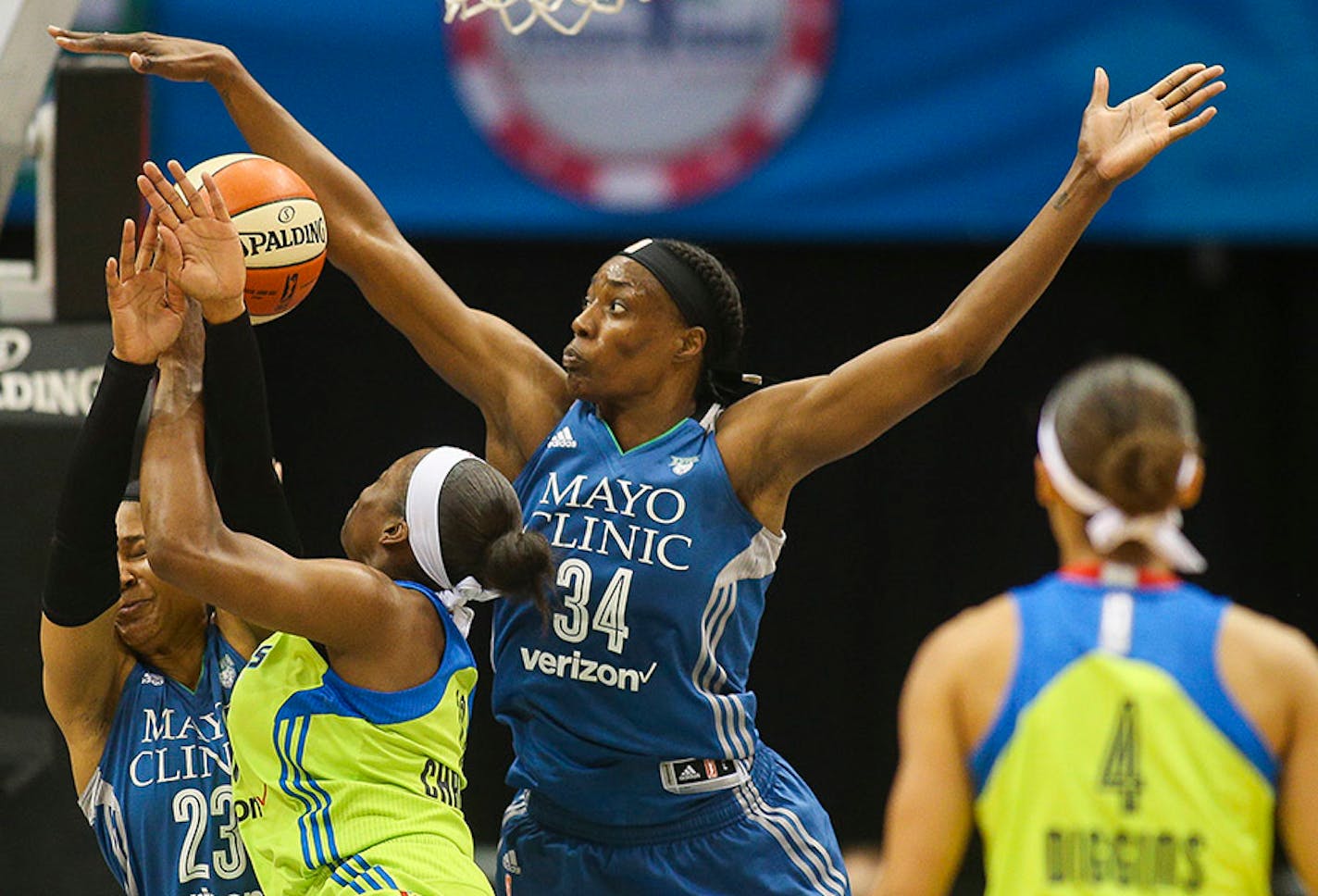 Minnesota Lynx center Sylvia Fowles (34) gets a piece of the ball as Dallas Wings forward Karima Christmas (13) drives to the basket during a game in June.