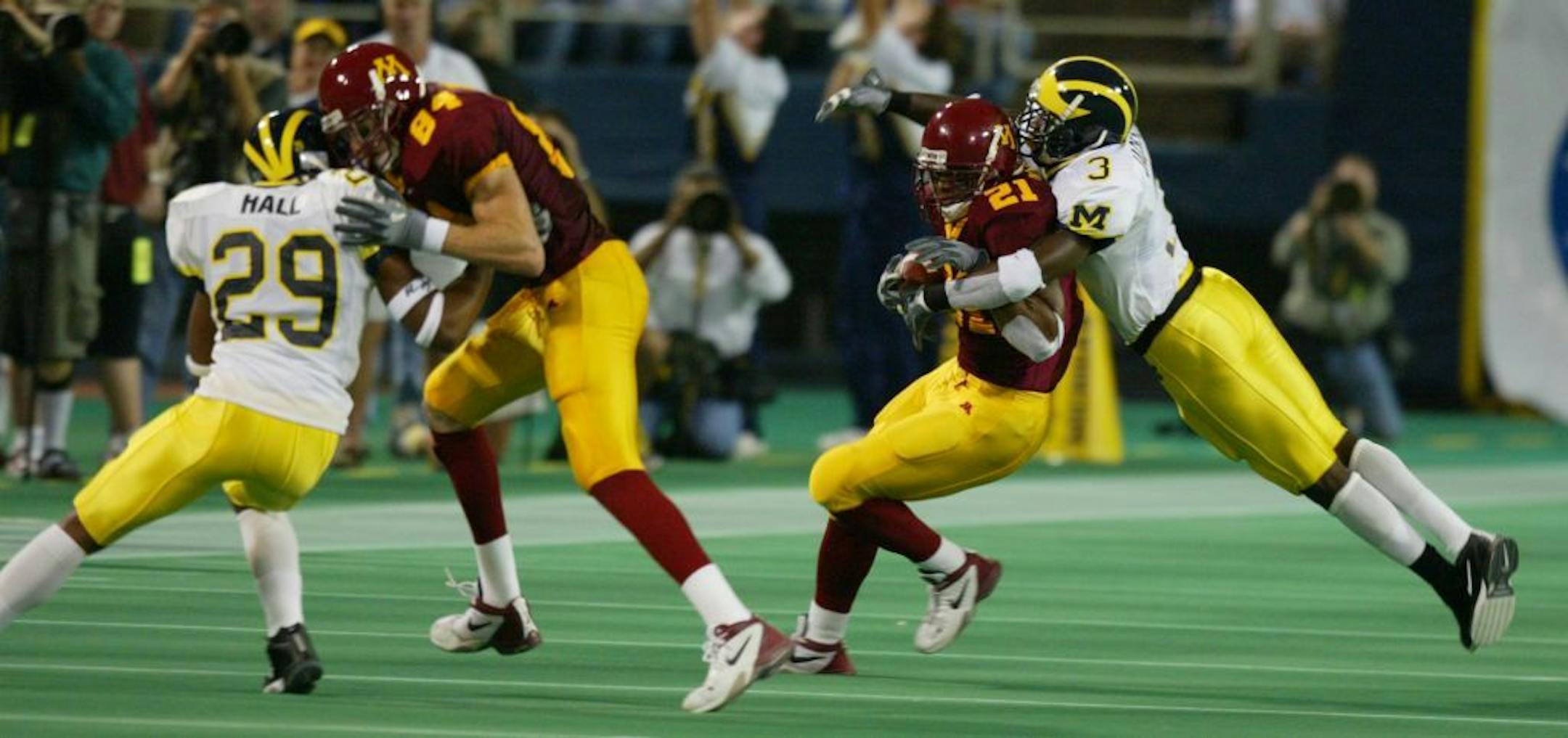 Minneapolis, Oct10, 2003 - gophers v michigan - Marion Barber tackled by ross Ryan after another first quarter first down.