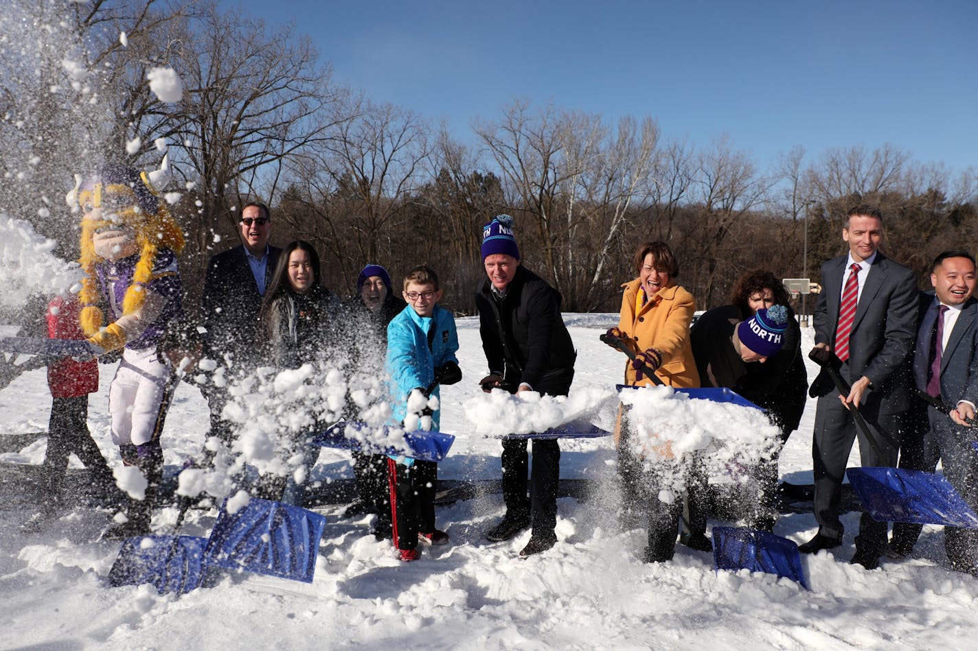 NFL Commissioner Roger Goodell, center, joined Sen. Amy Klobuchar, right, and Minneapolis Mayor Jacob Frey among others for a "snow shoveling ceremony" in place of ground breaking ceremony for the school's new athletic field.