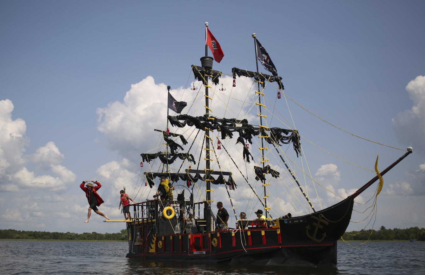 Brian Holeman walked the plank of the Coon Raider, Robert McCluskey's pirate ship on Coon Lake Tuesday afternoon. ] JEFF WHEELER &#x201a;&#xc4;&#xa2; jeff.wheeler@startribune.com Robert McCluskey turned a 25-foot Premier pontoon boat into a 55-foot pirate ship called the Coon Raider. He took the vessel out for a cruise on Coon Lake in Wyoming Tuesday afternoon, July 29, 2014, to show it off.