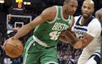 Boston Celtics's Al Horford, left, of Dominican Republic , drives around Minnesota Timberwolves' Taj Gibson as Kyrie Irving, right, sets a pick in the