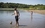 Jonathan Warren, 14, of Richfield, carried some fish he and a few friends had caught while at at Fort Snelling State Park in St. Paul , Minn., on July