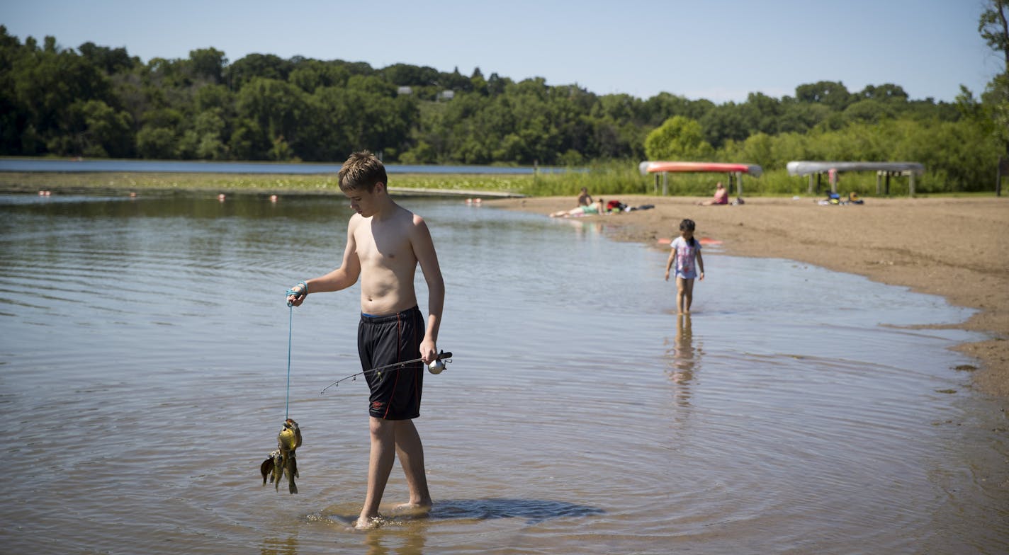 Jonathan Warren, 14, of Richfield, carried some fish he and a few friends had caught while at at Fort Snelling State Park in St. Paul , Minn., on July 3, 2017. ] RENEE JONES SCHNEIDER &#x2022; renee.jones@startribune.com