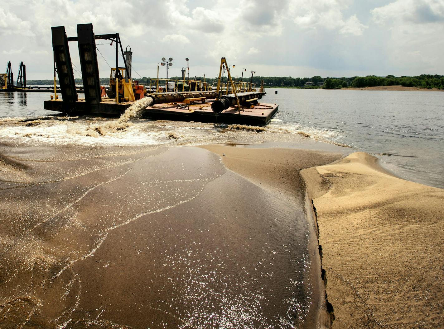 This dredge cuts a 200 foot swath into the navigation channel, insuring a 12-foot deep channel. The sand is dumped on the edge of the channel and will be removed later after safe navigation is restored.