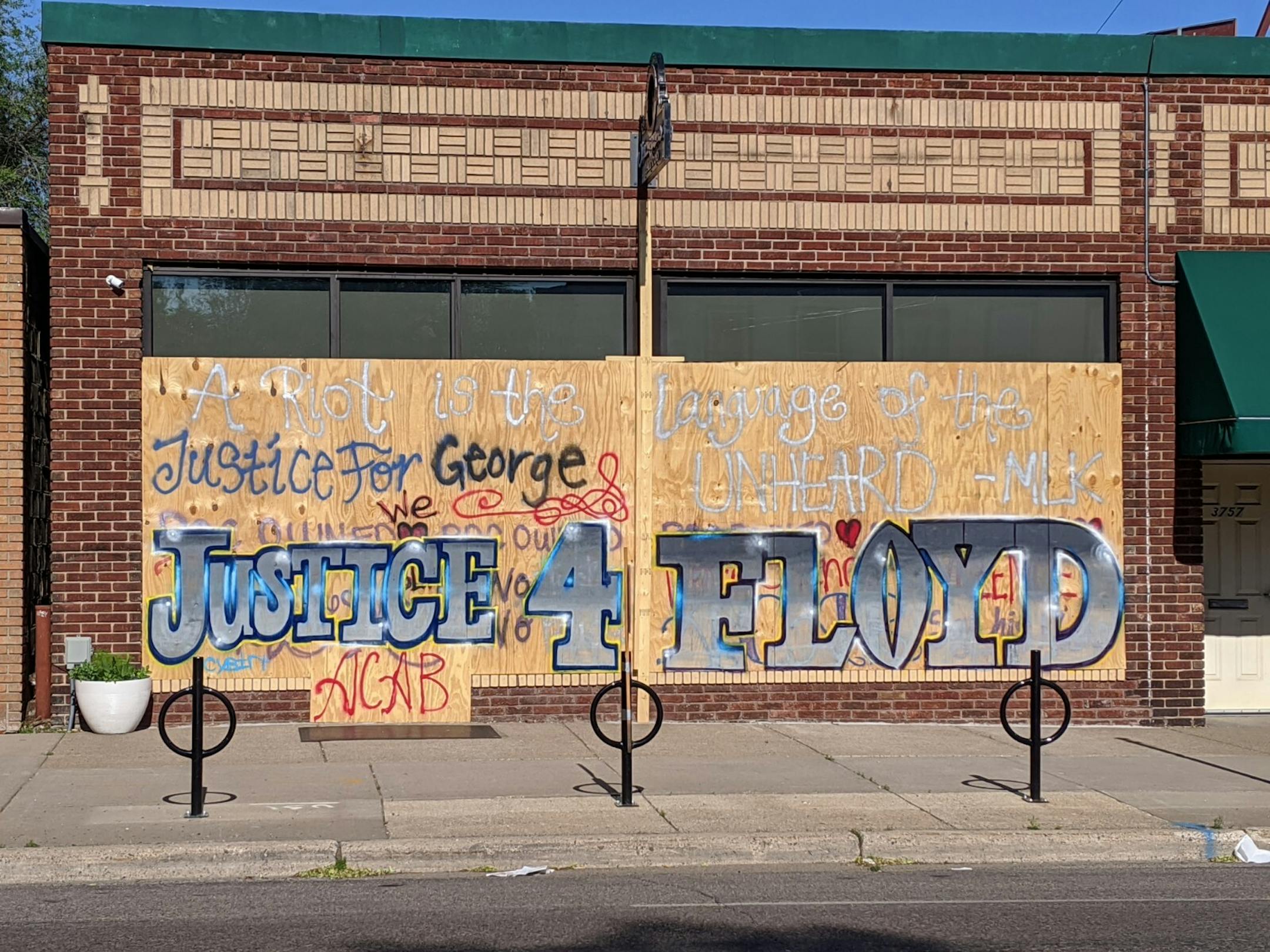 Graffiti covering the boarded up windows of Jackalope Tattoo at 3753 Cedar Ave. S. demand justice for George Floyd, the black man whose death by Minneapolis police has set off a cry for change heard around the world.