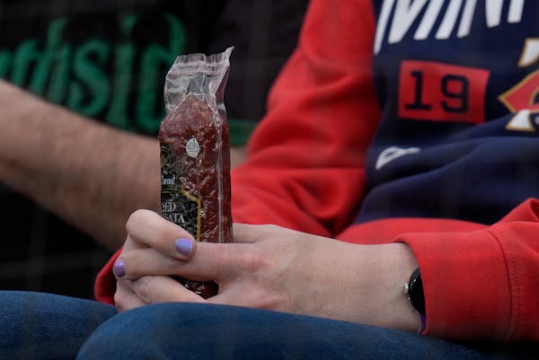 A Twins fan holds a sausage before Monday's game in Chicago.