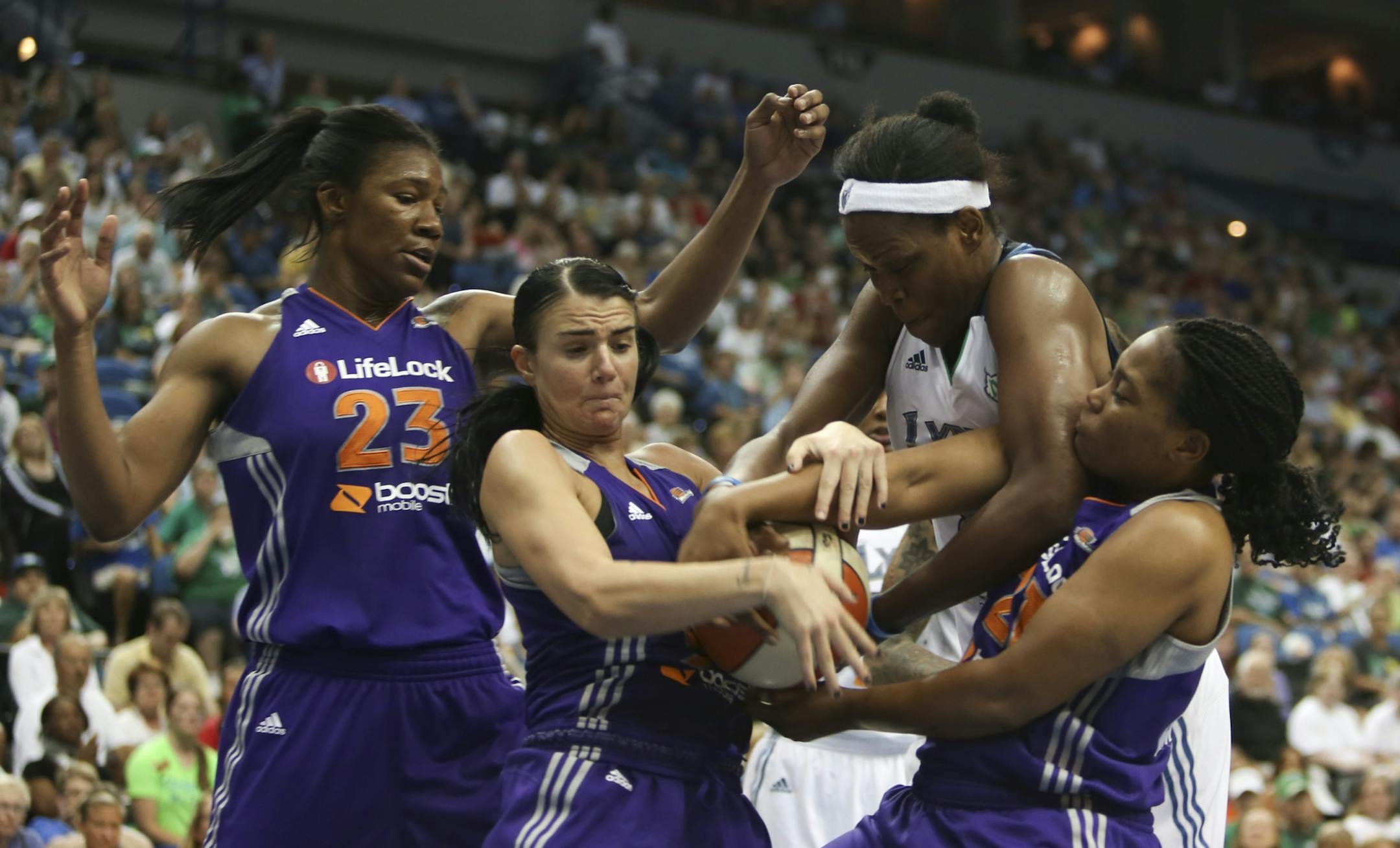 Lynx Taj McWilliams-Franklin fought for a rebound with Phoenix's Samantha Prahalis, left and Alexis Gray-Lawson with Phoenix's Avery Warley watching far left during the second half at the Target Center in Minneapolis, Min., Wednesday, June 27, 2012. Lynx won 96-80.