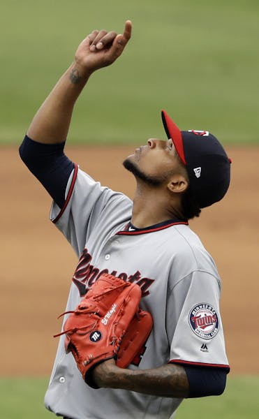 Minnesota Twins starting pitcher Ervin Santana points skyward after getting the last out in the ninth inning and pitching a complete baseball game aga