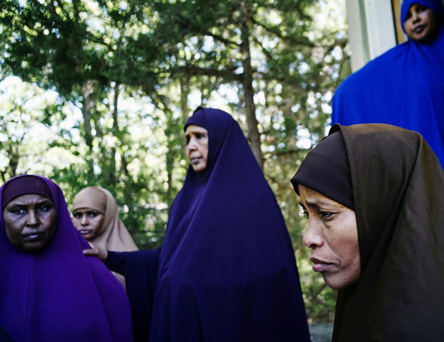 In Wilmar, far right, Lul Mohamed grieved for her son Ahmed Ashi, 11 who drowned along with childhood friend Idris Hussein,11, at nearby Foot Lake near the dock. [ Richard Tsong-Taatarii/rtsong-taatarii@startribune.com