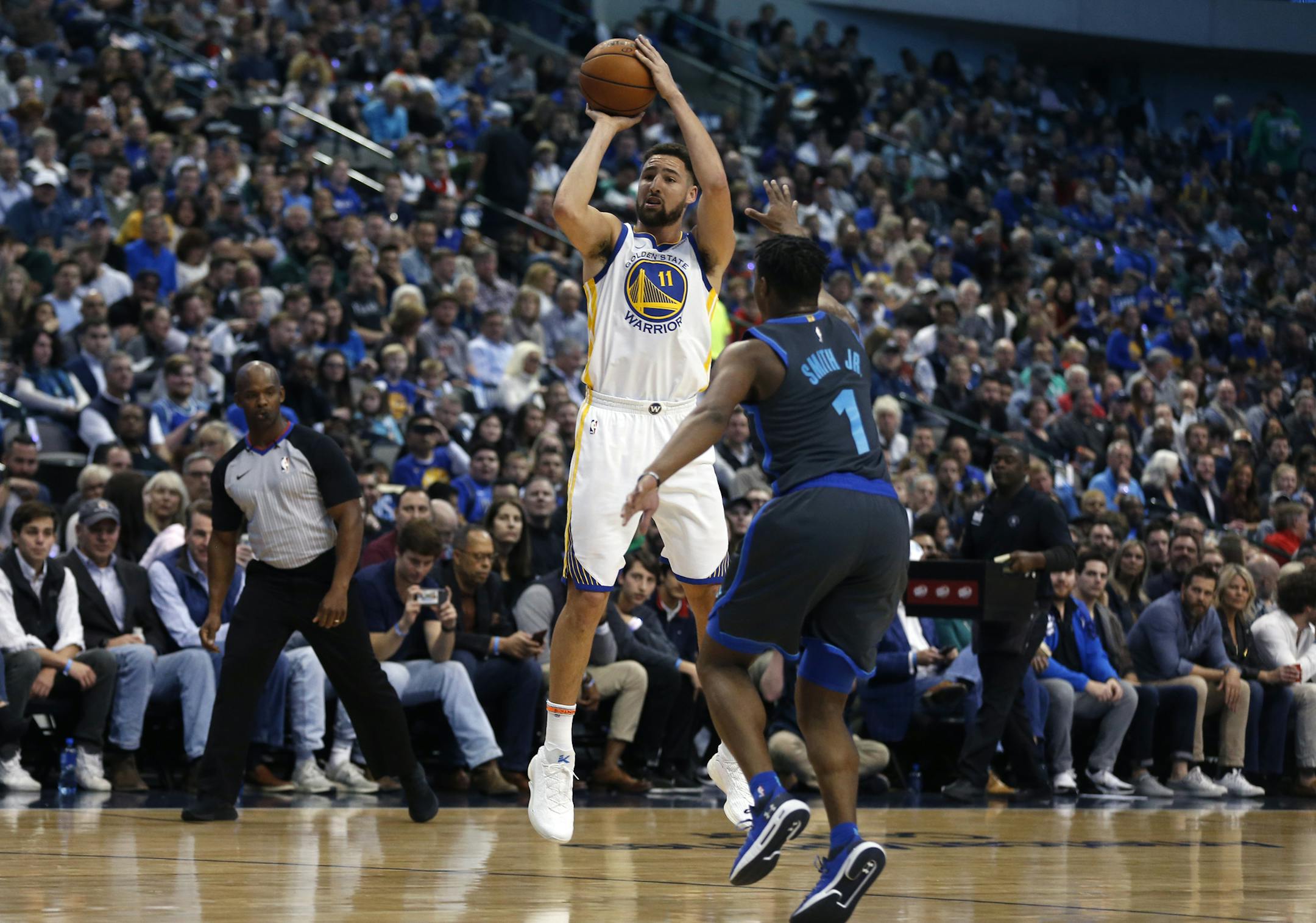 Golden State Warriors guard Klay Thompson (11) shoots over Dallas Mavericks guard Dennis Smith Jr. (1) during the first half of an NBA basketball game, Saturday, Nov. 17, 2018, in Dallas. (AP Photo/Ron Jenkins) ORG XMIT: OTK