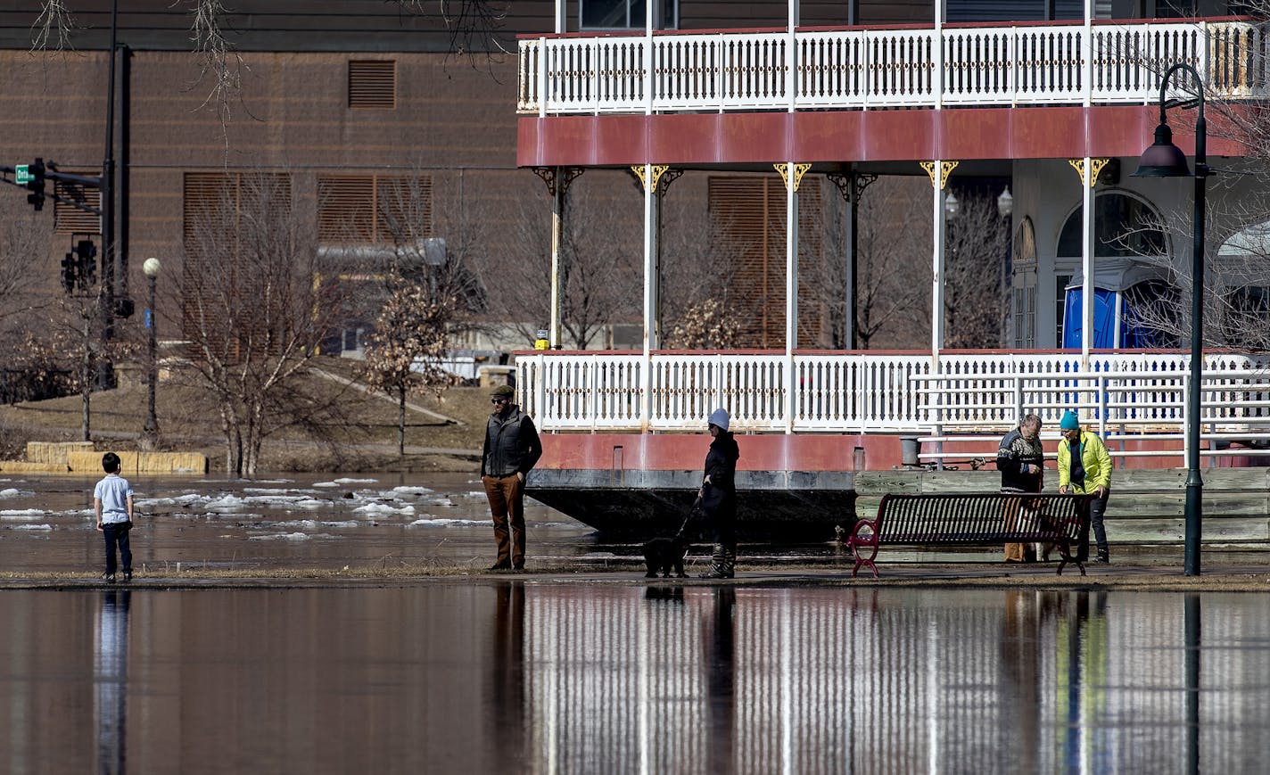 Pedestrians in St. Paul came out to view the flooding at Harriet Island Regional Park and the flowing Mississippi River on Monday afternoon.