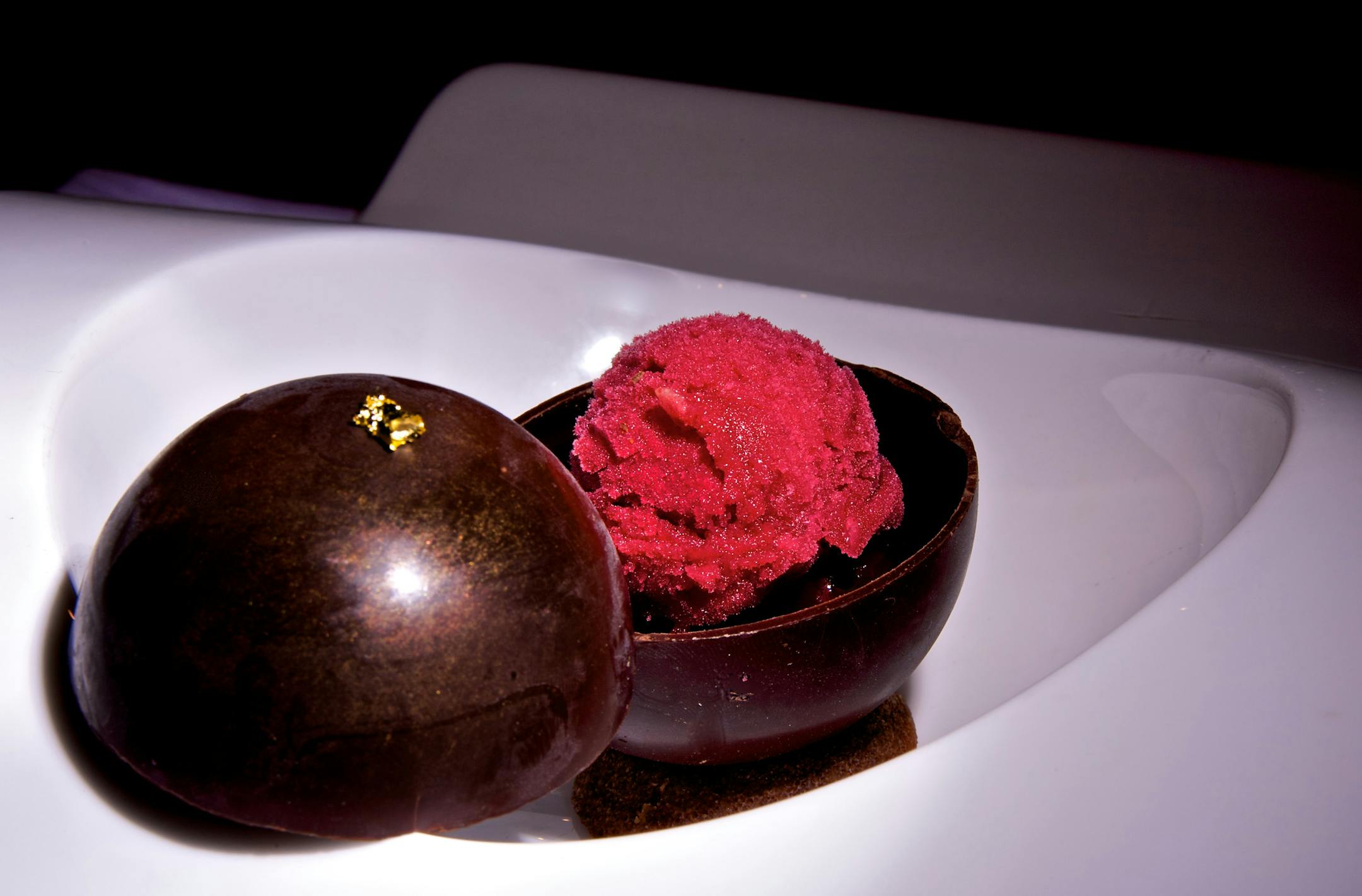 Cosmos pastry chef Khanh Tran made this Cosmos Chocolate Globe with Valrhona chocolate cremeaux, brandied cherries, cherrie sorbet and warm chocolate is poured table side.