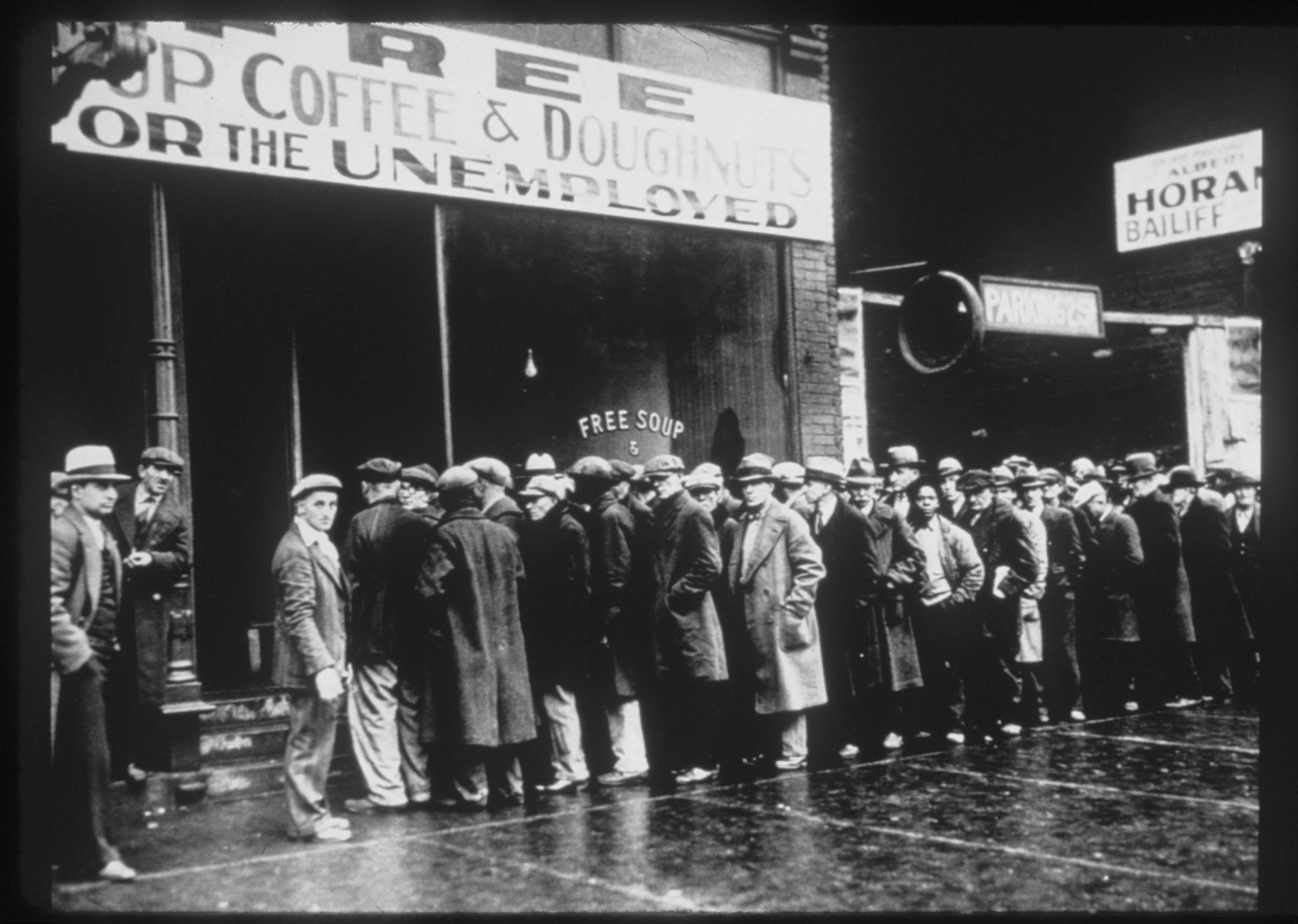 Photo shows people waiting in line at a soup kitchen during the Depression. Photo accompanies publicity for the television documentary "The Great Depression" on The History Channel, March 1998. Photo from the National Archives, courtesy of CORBIS.