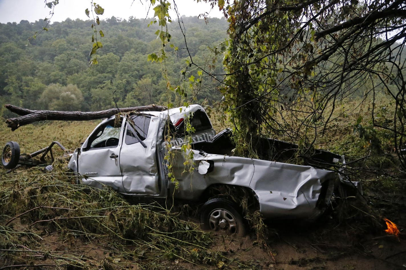 A pickup truck had washed several hundred yards away from where it had been parked near Cashton, Wisc. The hazard lights on the back were still blinking.