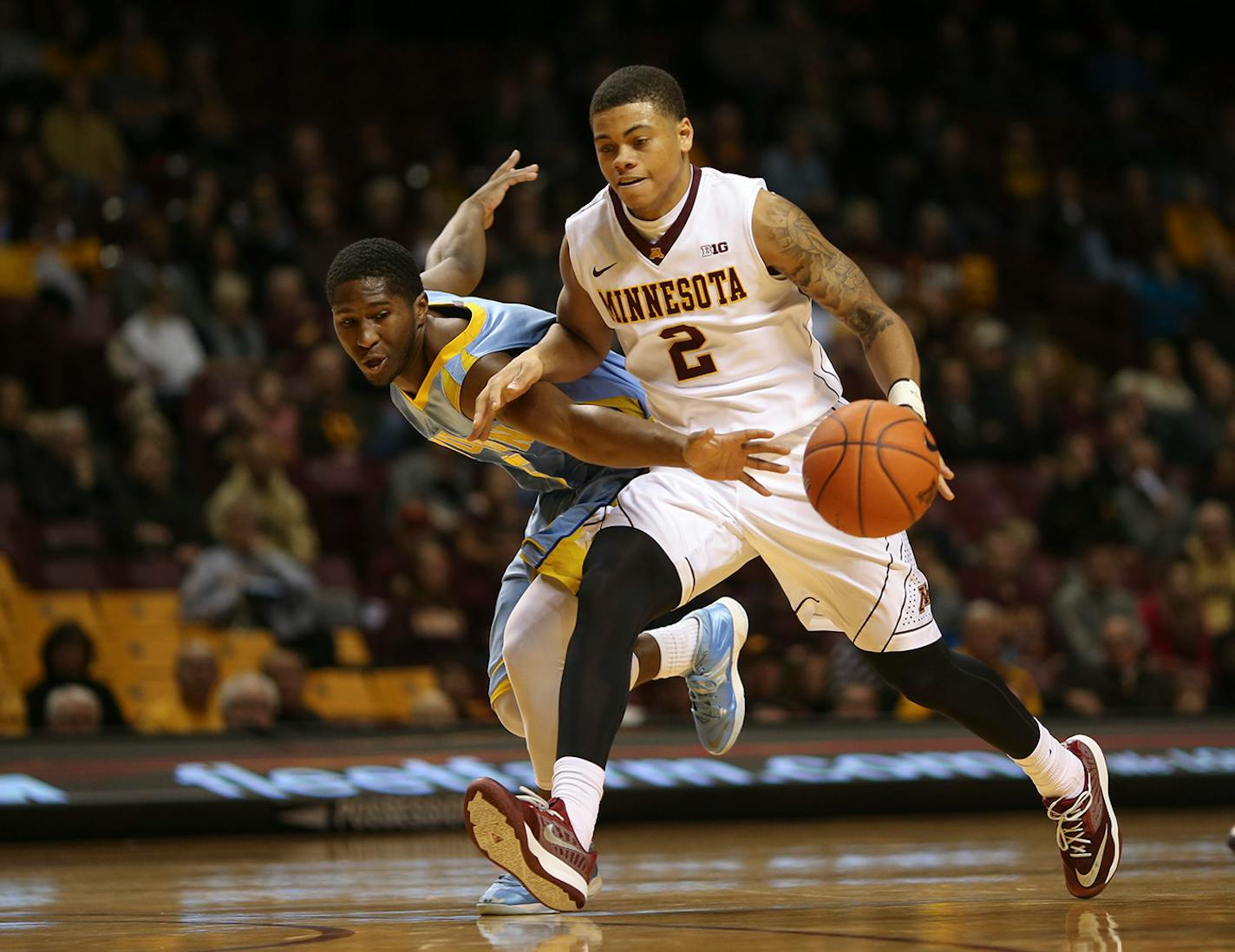 Gophers guard Nate Mason (2) outran the defense of Southern University Jaguars guard Michael Harrel (5) while driving up court in the second half Wednesday night at Williams Arena. ] JEFF WHEELER • jeff.wheeler@startribune.com The University of Minnesota men's basketball team trounced Southern University 85-57 at Williams Arena Wednesday night, December 10, 2014 in Minneapolis.