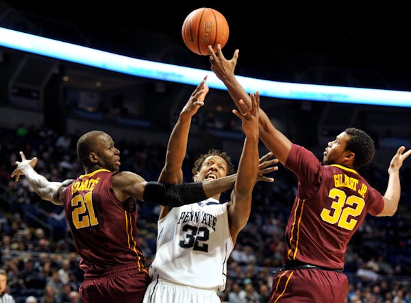 Penn State's Jordan Dickerson (32) fights for the ball with Minnesota's Bakary Konate (21) and Ahmad Gilbert (32) at the Bryce Jordan Center in Univer