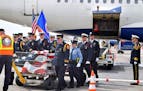 About two dozen Twin Cities firefighters and police officers volunteered as an honor guard Sunday afternoon at Mpls.-St. Paul International airport as