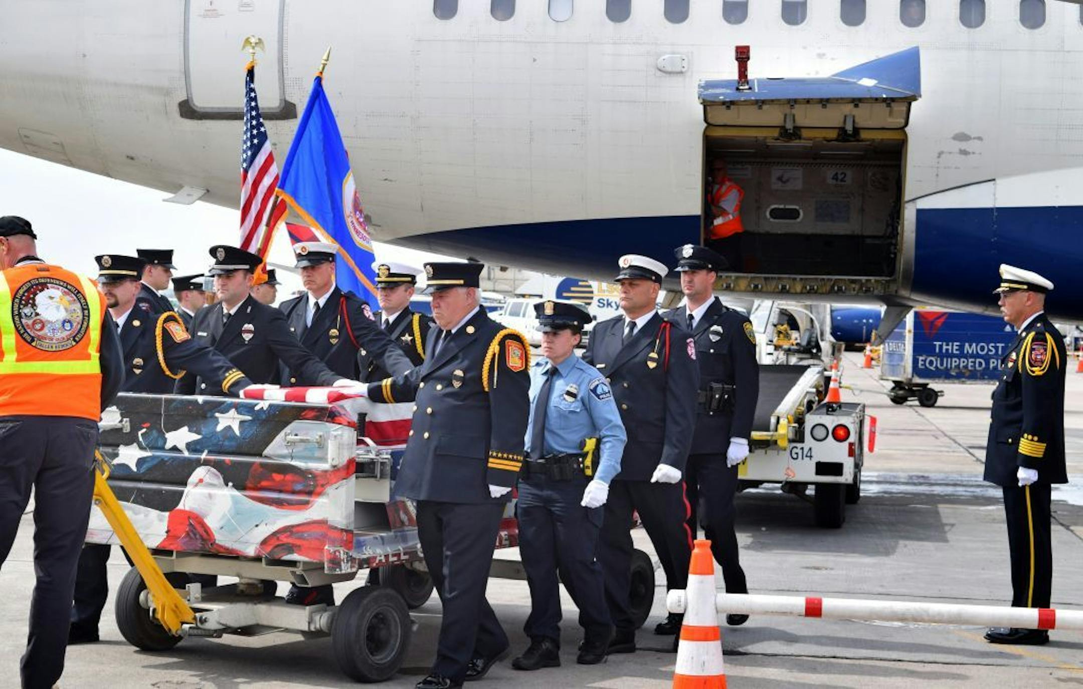 About two dozen Twin Cities firefighters and police officers volunteered as an honor guard Sunday afternoon at Mpls.-St. Paul International airport as the body of a dive team member arrived there en route to North Dakota. Lori Pohanka-Kalama, a member of the Morgan's Point fire and police dive team in central Texas, died while searching for a soldier who got swept away in a rain-swollen creek.