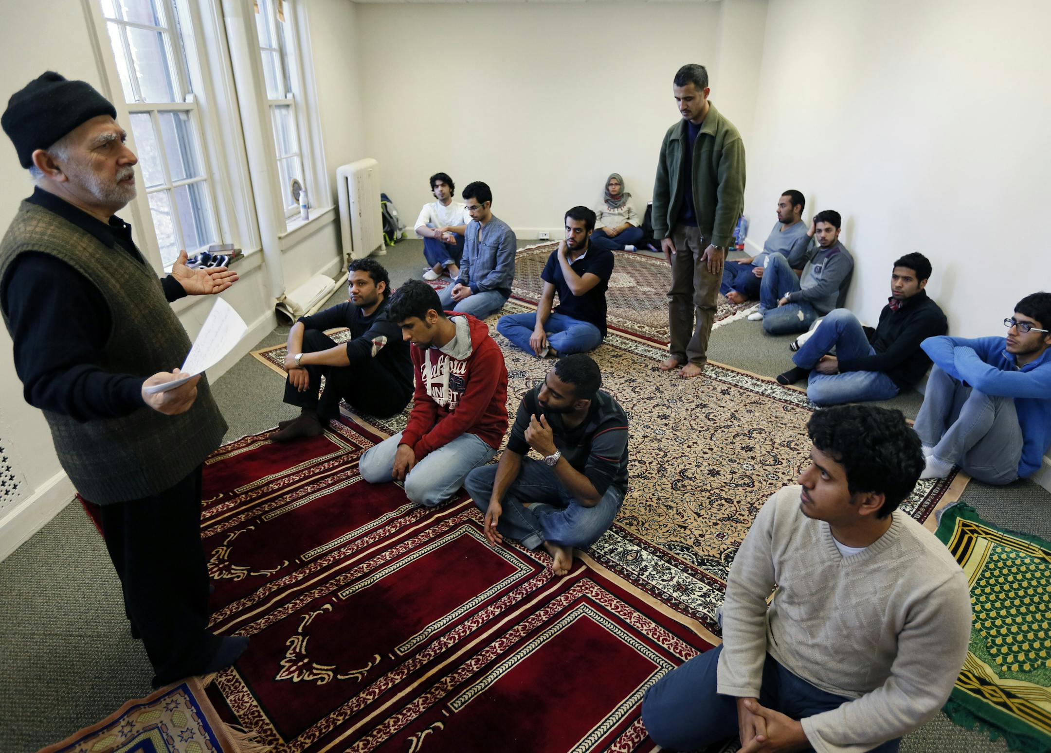 This fall, the University of St. Thomas converted two rooms in an old seminary building into Muslim prayer spaces. It even installed "ablution stations" to enable men and women to wash before prayers. For the Catholic university, it's a symbol of the growing presence of foreign students from Islamic countries. This year, more than 100 of the 400 international students on campus are from Saudi Arabia. Here, Prof. Ozdemir (left), who leads the service, and is co-director of the Muslim-Christian Di