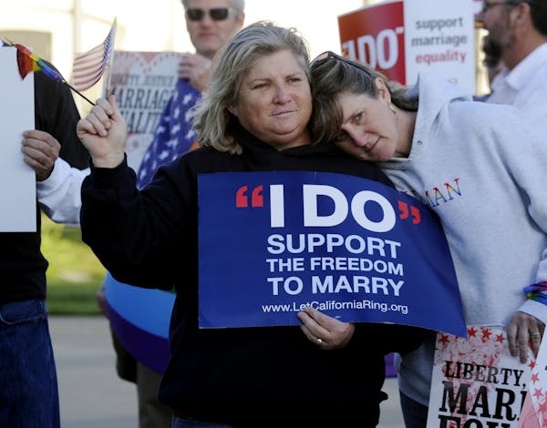 Kim Roberts, left, and her partner Lisa Mayes of Benicia, Calif. participate in a marriage equality rally on March 26, 2013.