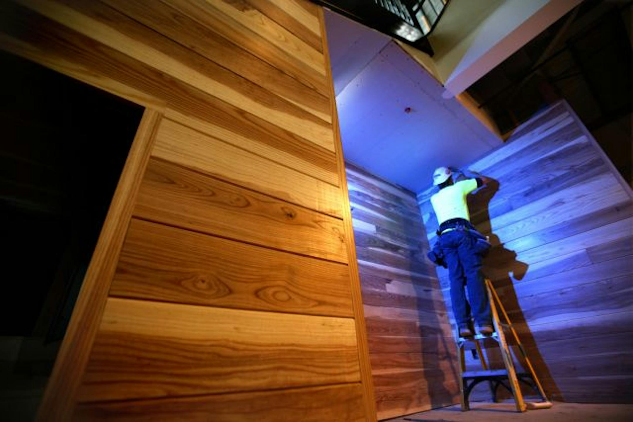 Reid Lemaire of Crossroads Construction worked on an area of white ash paneling at the new Eagan Fire Safety Center. The ash was salvaged from approximately 100 trees that were cut as defense against the emerald ash borer.