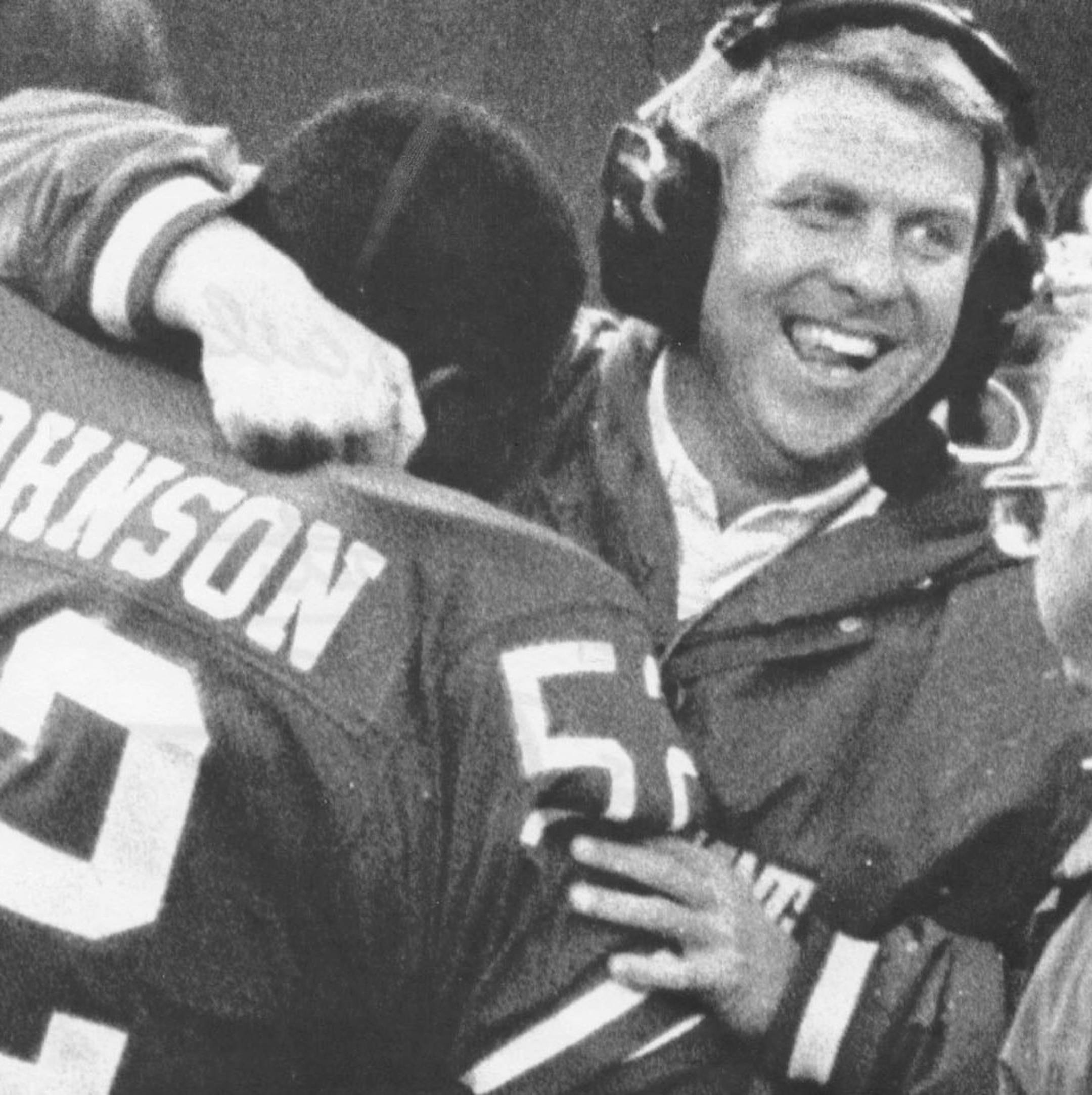 Bill Parcells, head coach of the New York Giants pro football team, hugs Thomas Johnson after Johnson intercepted a Green Bay Packer pass in the fourth quarter of action at Giant Stadium, 12/20/1986. The Giants went on to win the game. United Press International photo by Richard Harbus. ORG XMIT: MIN2013080218060056