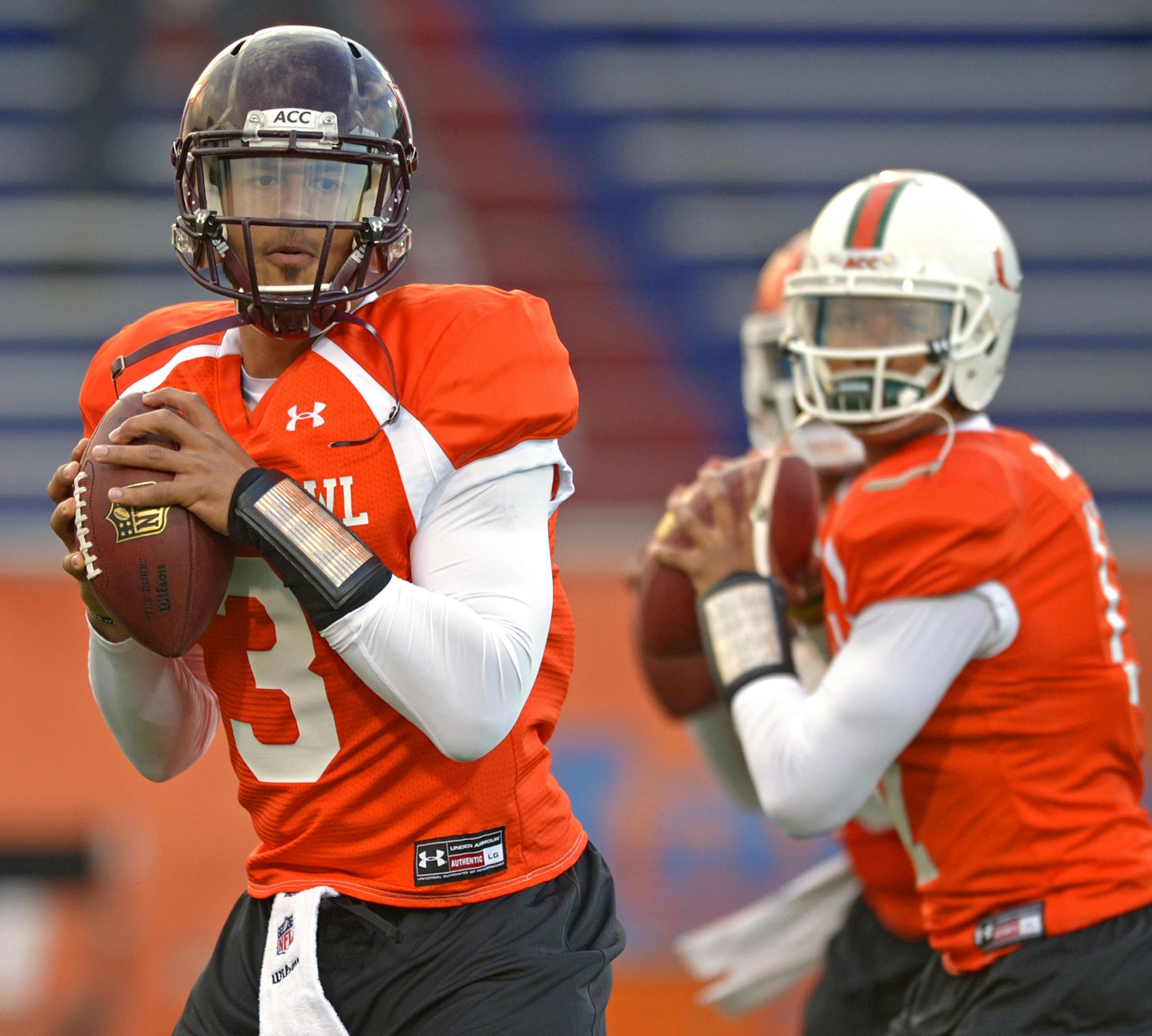 North Squad quarterback Logan Thomas of Virginia Tech (3) drops back with fellow quarterbacks Tajh Boyd of Clemson (10), middle, and Stephen Morris of Miami (17), right, during Senior Bowl practice at Ladd-Peebles Stadium, Monday, Jan. 20, 2014, in Mobile, Ala. (AP Photo/G.M. Andrews)
