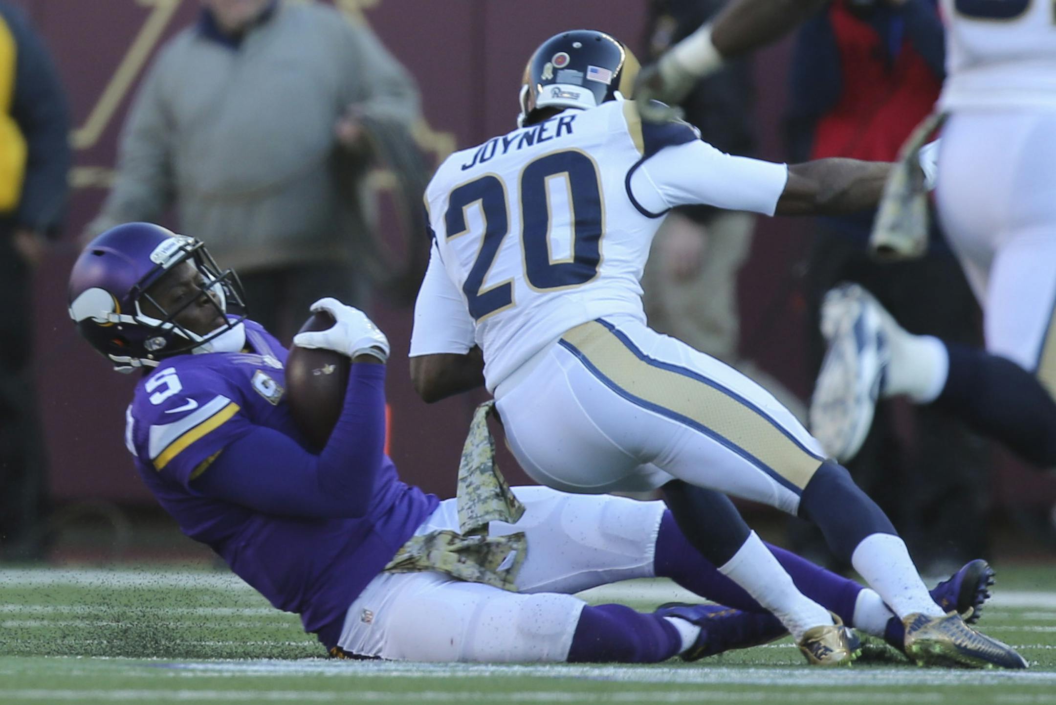 Vikings quarterback Teddy Bridgewater scrambled for a five yard gain before being hit hard by Rams cornerback Lamarcus Joyner (20) as he slid to the ground in the fourth quarter Sunday afternoon. Joyner was penalized for unnecessary roughness on th play. Bridgewater left the game after the hit. ] JEFF WHEELER &#xef; jeff.wheeler@startribune.com The Minnesota Vikings beat the St. Louis Rams 21-18 in overtime on a 40 yard Blair Walsh field goal Sunday afternoon, November 8, 2015 at TCF Bank Stadiu