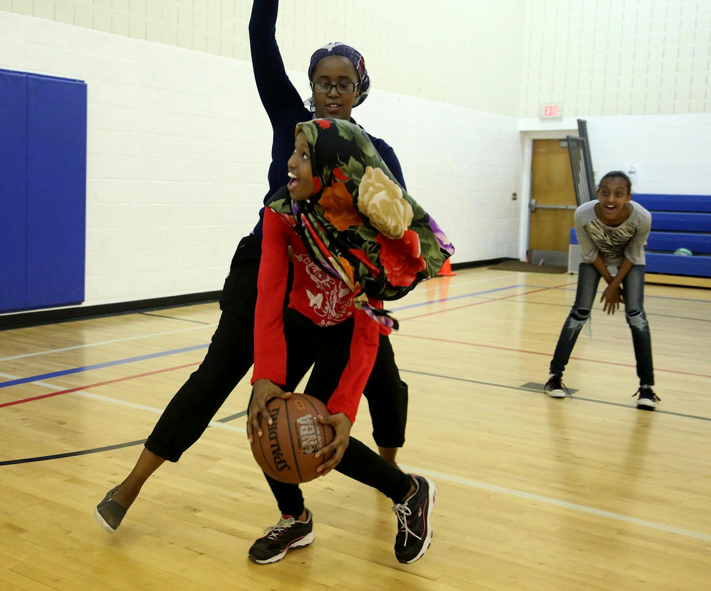 Assistant coach Muna Mohamed, a junior at Augsburg College, played defense against Amal Ali, 11, at the Brian Coyle Community Center in Minneapolis.