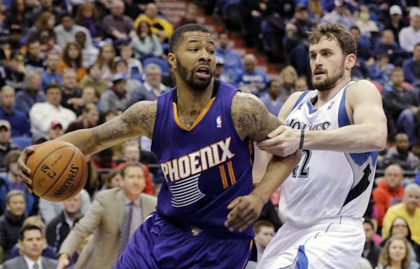 Phoenix Suns forward Markieff Morris drove Timberwolves forward Kevin Love during the second quarter Sunday.