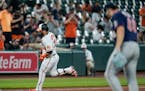 Baltimore Orioles' DJ Stewart, left, runs the bases after hitting a two-run home run against Minnesota Twins starting pitcher Randy Dobnak, right, dur