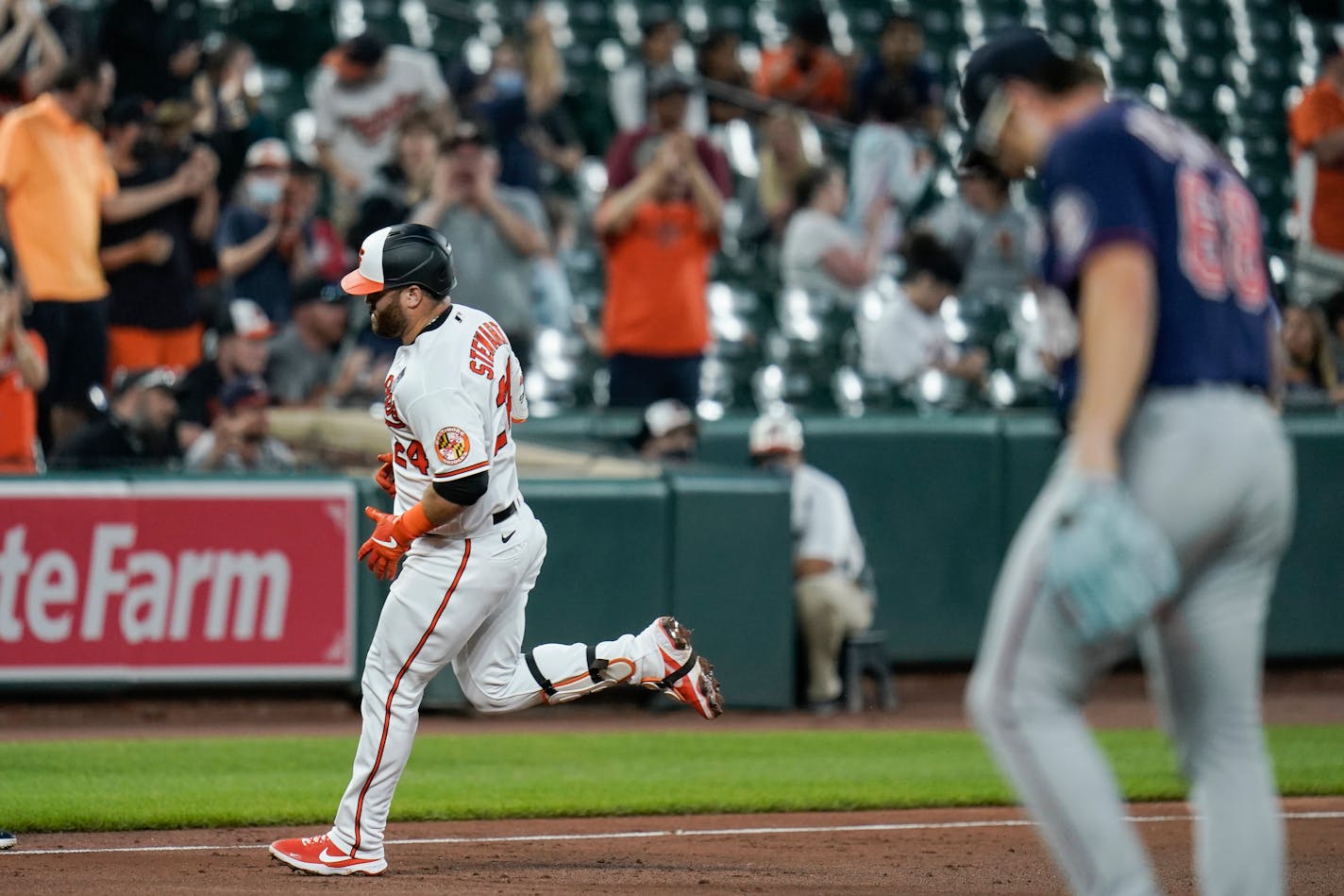 Baltimore Orioles' DJ Stewart, left, runs the bases after hitting a two-run home run against Minnesota Twins starting pitcher Randy Dobnak, right, during the fifth inning of a baseball game, Wednesday, June 2, 2021, in Baltimore. Orioles' Freddy Galvis scored on the home run. (AP Photo/Julio Cortez)