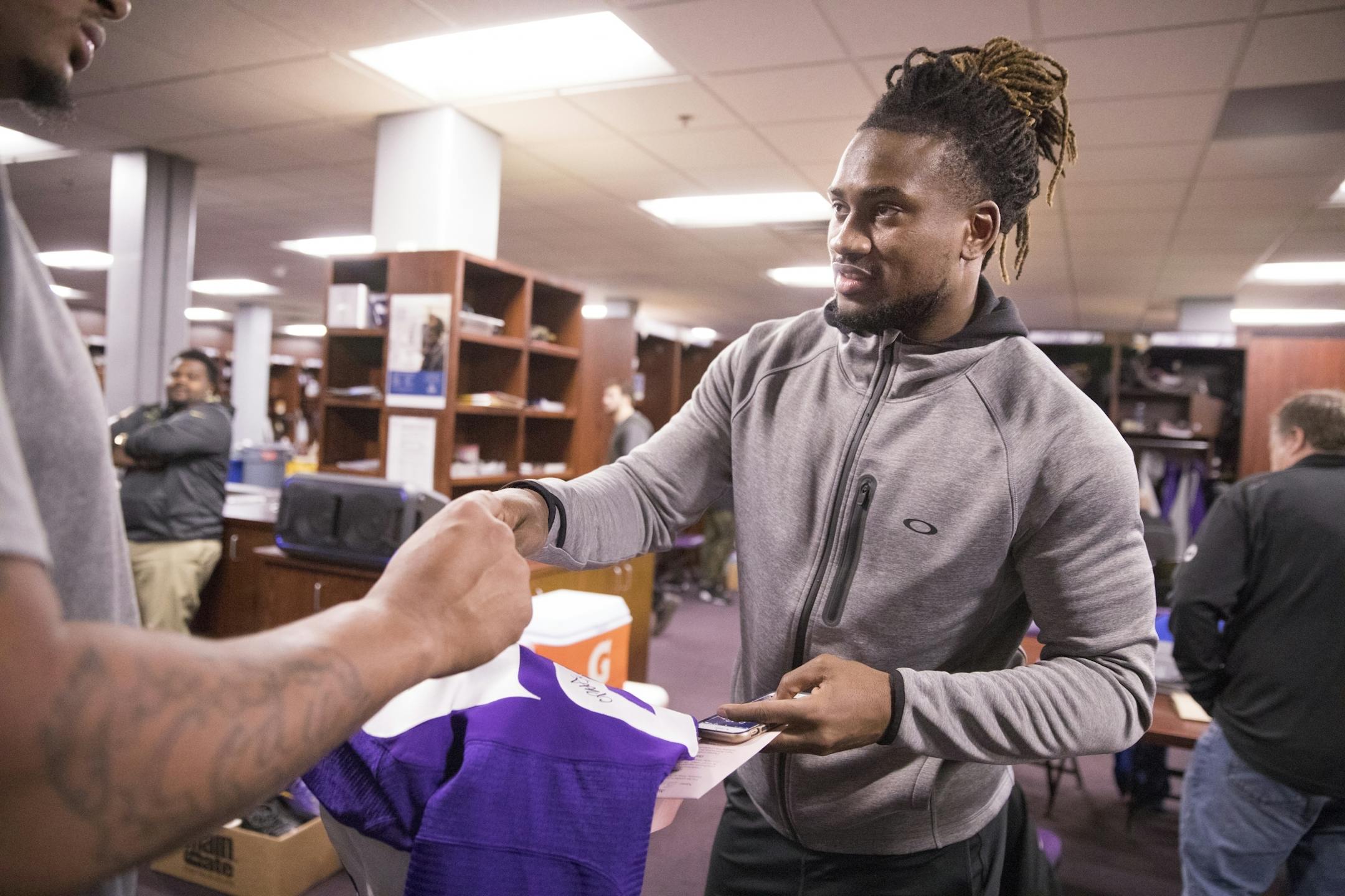 Cordarrelle Patterson signs a jersey for a teammate.