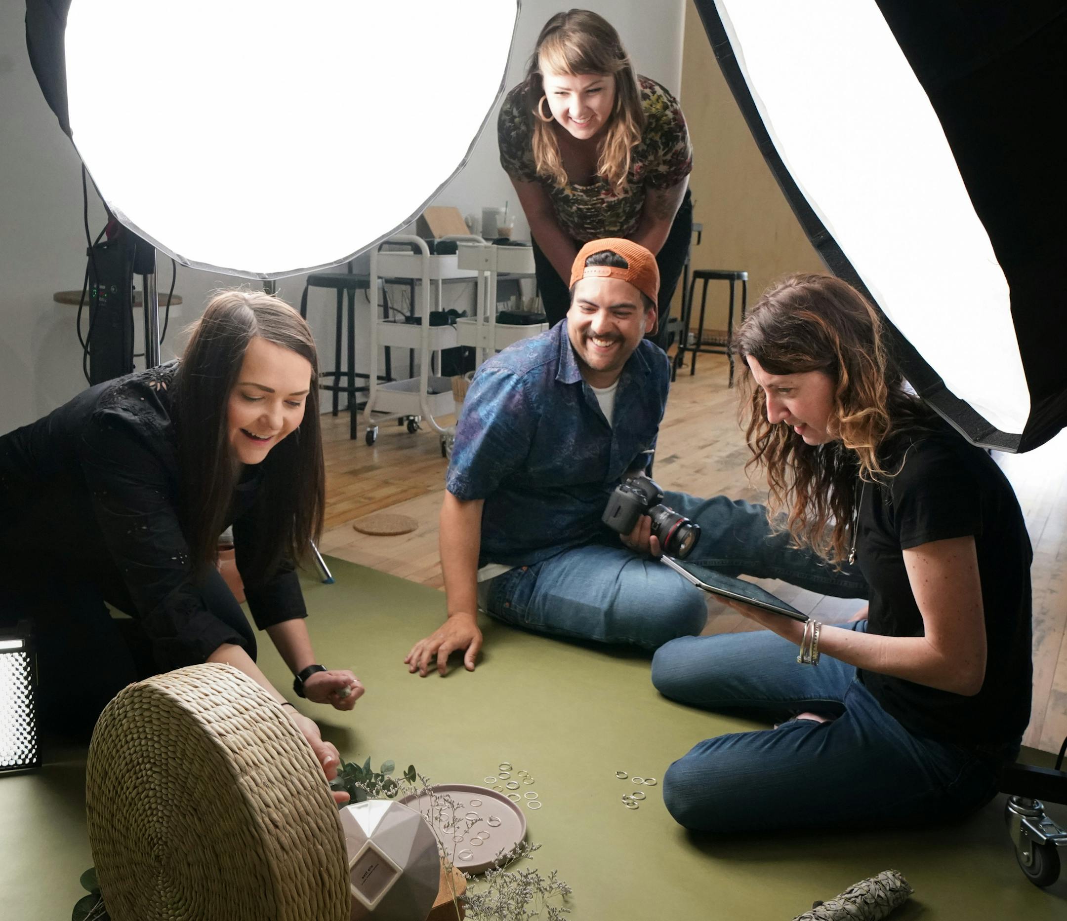 Soona cofounders Liz Giorgi, left, and Hayley Anderson, center, assisted in the jewelry photo shoot with studio pro Andres Perez and client Aisha Formanski, right. ] GLEN STUBBE &#x2022; glen.stubbe@startribune.com Thursday, June 6, 2019 Soona Minneapolis is a new production studio that has a unique model to produce same-day photos and videos for advertisers.