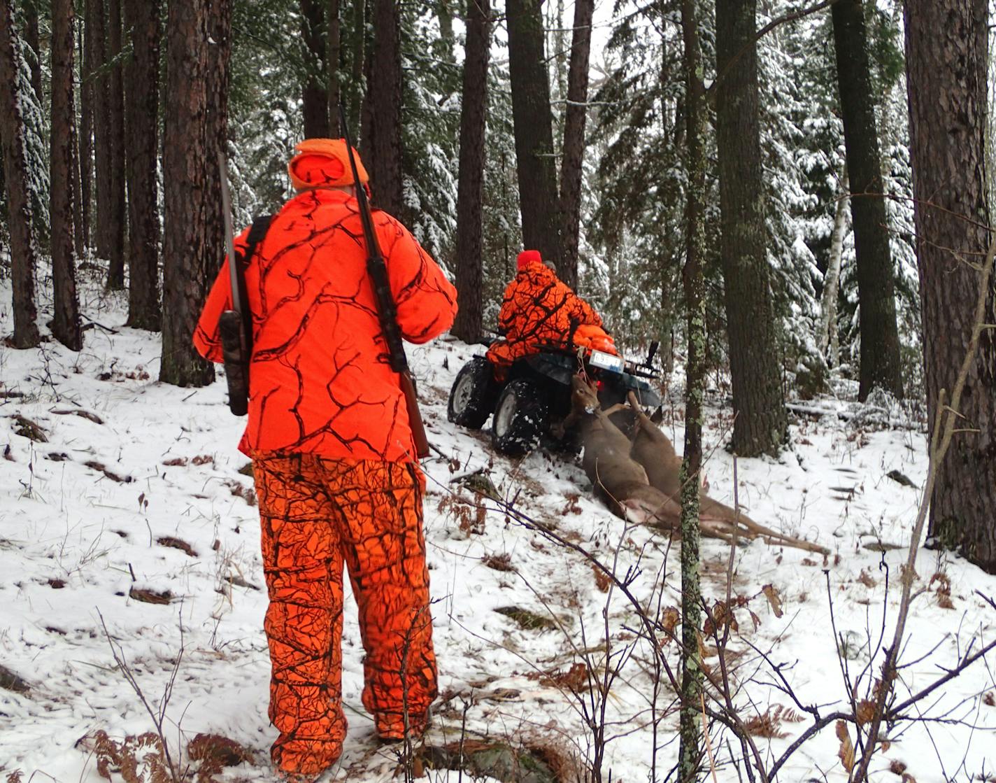 Hunting with Dennis Anderson on Saturday in northern Minnesota were, left, his brother Dick, his nephew Brian, on four-wheeler, and his son, Cole. Wet snow fell early in the morning. ORG XMIT: MIN1311091450019795