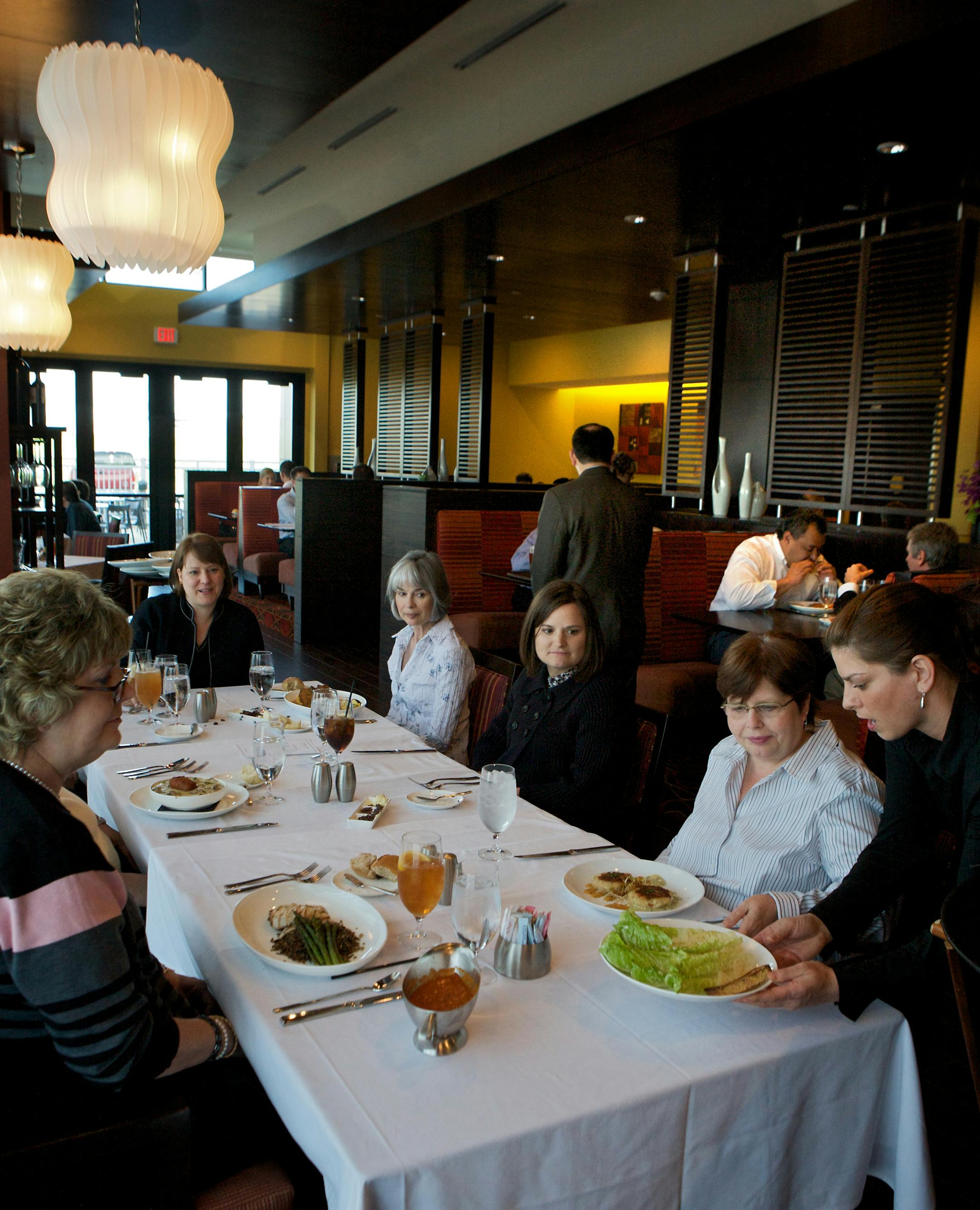 Kelly Ekerholm, far right, serves lunch at the ChopHouse in the Hilton Hotel.