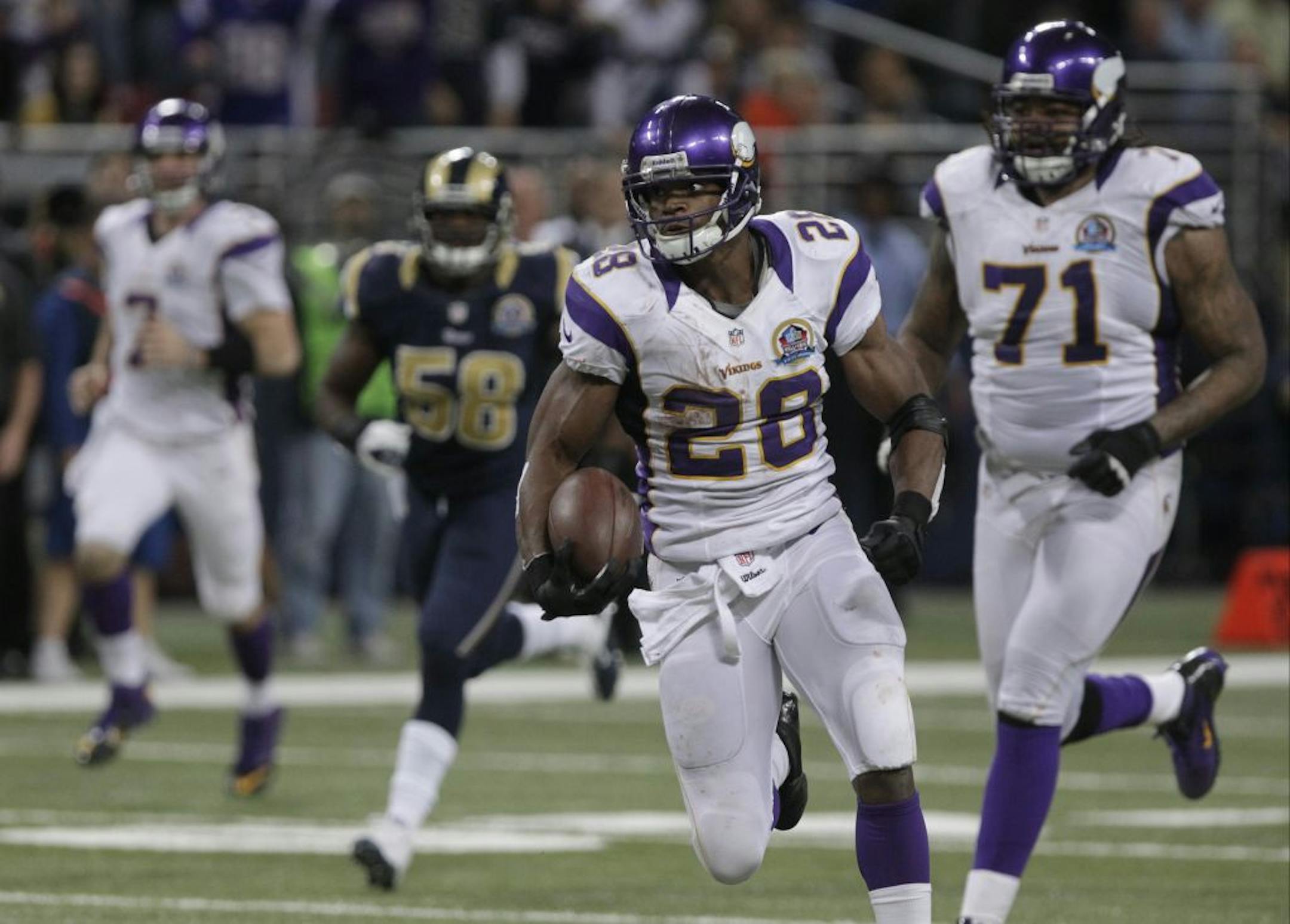 Minnesota Vikings running back Adrian Peterson runs past a host of St. Louis Rams defenders on his way to a 52-yard touchdown run.