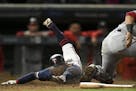 Minnesota Twins infielder Ronald Torreyes dove safely into home off a single by outfielder LaMonte Wade Jr. (30) as Washington Nationals catcher Yan G