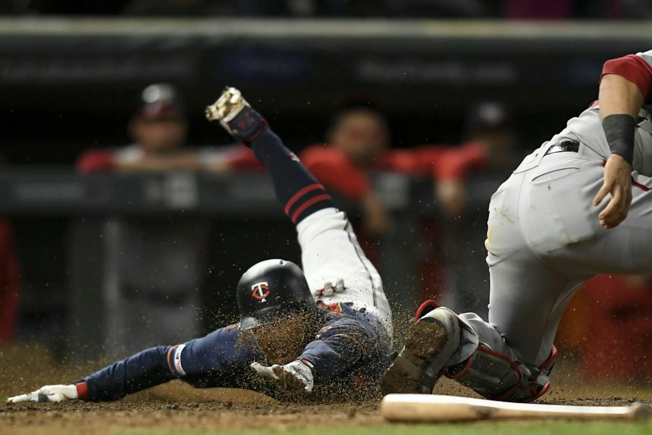 Minnesota Twins infielder Ronald Torreyes dove safely into home off a single by outfielder LaMonte Wade Jr. (30) as Washington Nationals catcher Yan Gomes (10) was unable to get the out in the bottom of the eighth inning.