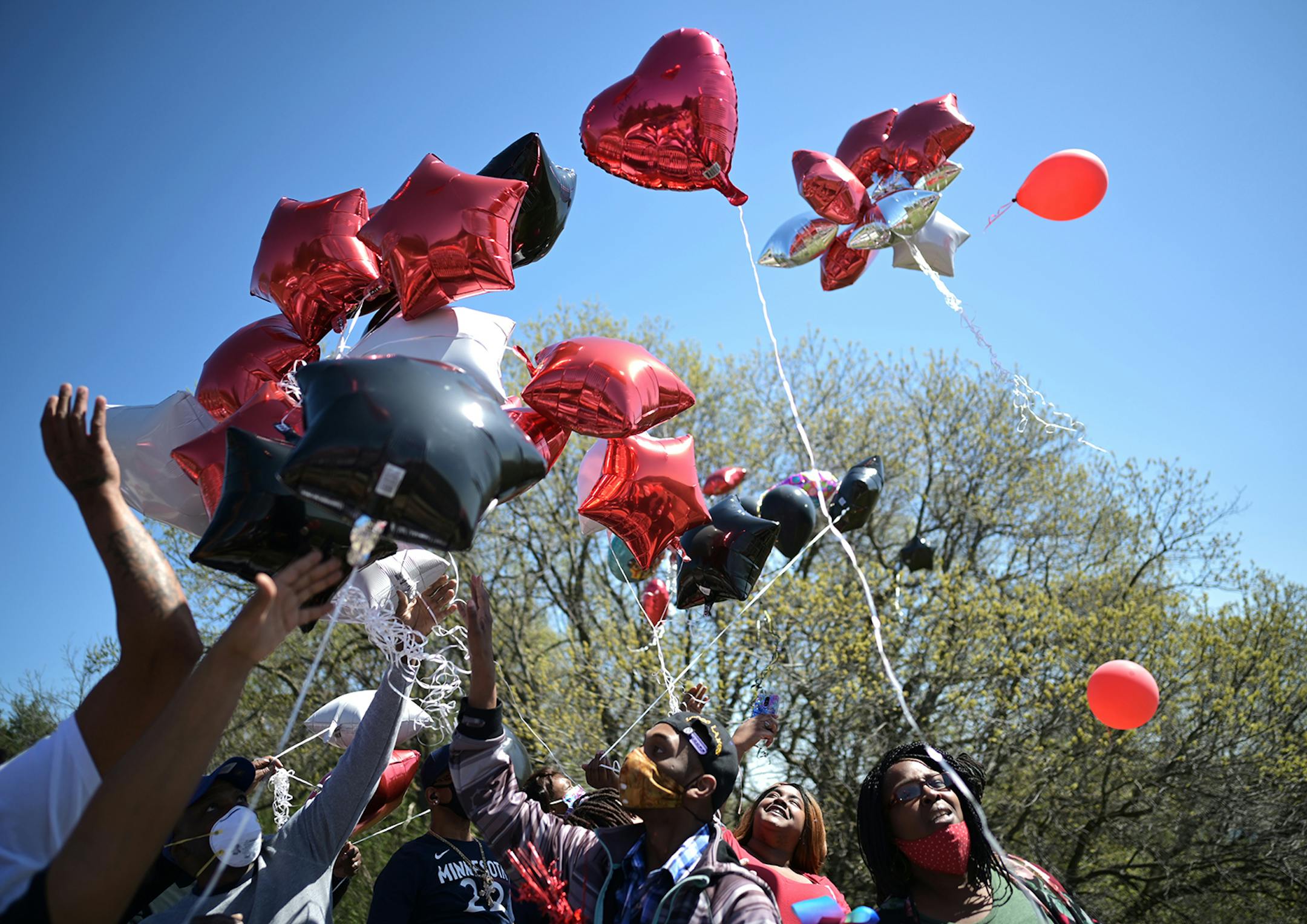 Family and friends of Douglas Lewis released balloons into the air after his sister, Valerie Lewis, said a few words at his memorial. A memorial was held for Lewis, who was shot and killed Friday night, on Sunday, May 3, 2020 at the Burns Avenue Scenic Overlook in St. Paul, Minn.