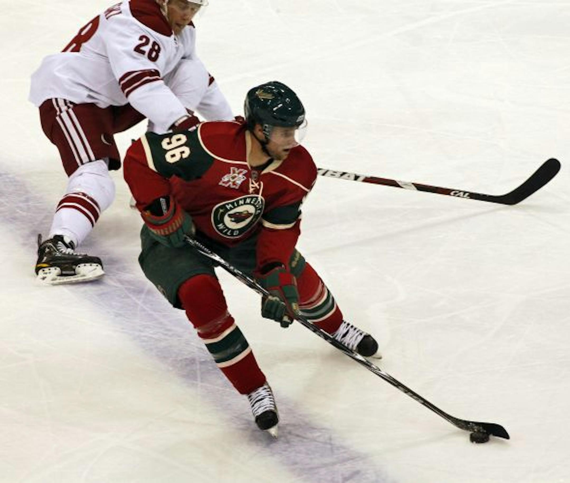 .The Wild's Pierre-Marc Bouchard (96) returned to the ice Wednesday night. Phoenix'sLauri Koaarpikoski skated in the background.