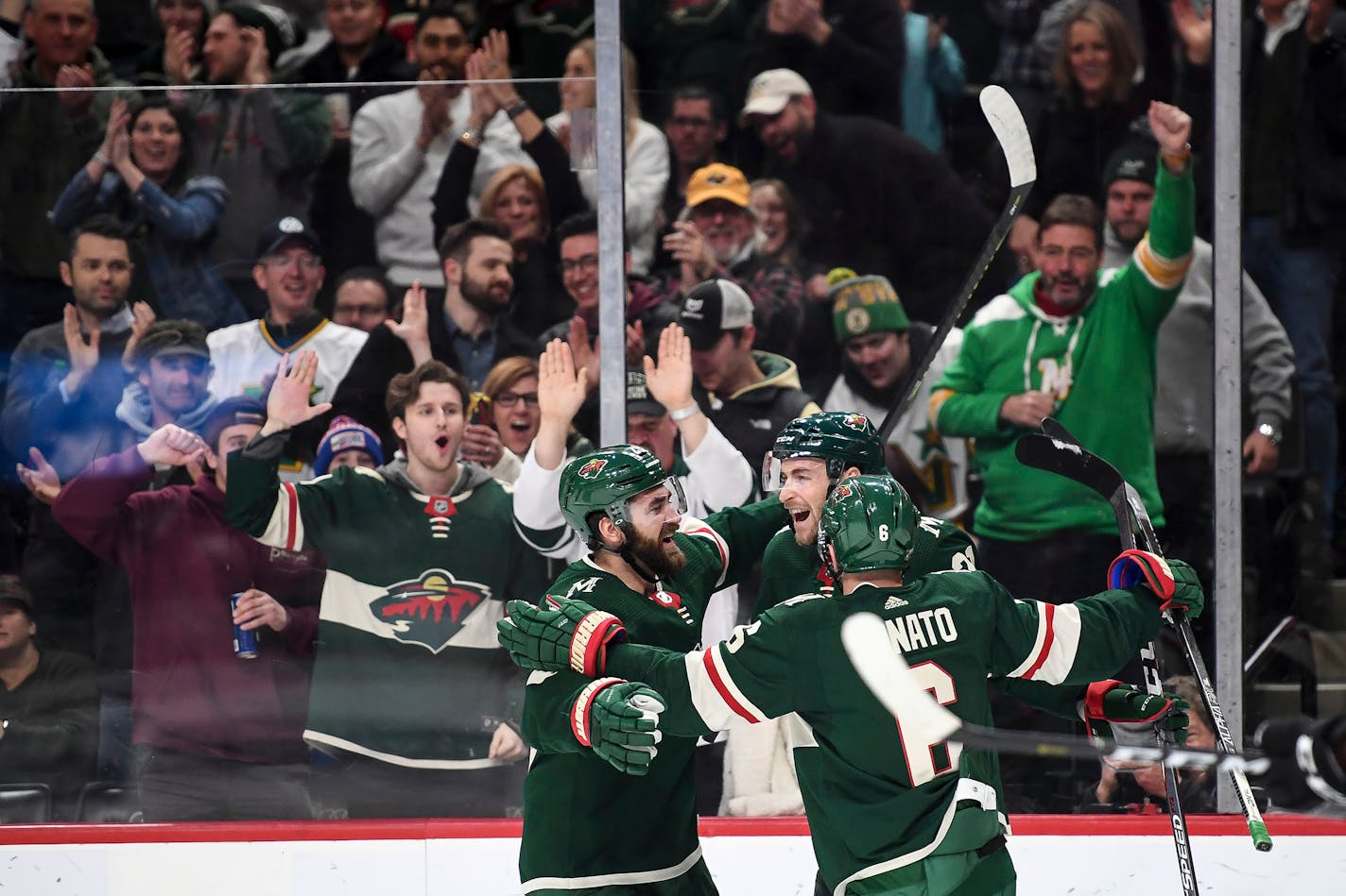 Greg Pateryn (29), Carson Soucy (21) and Ryan Donato (6) celebrated a second period goal scored by Soucy against the Stars.