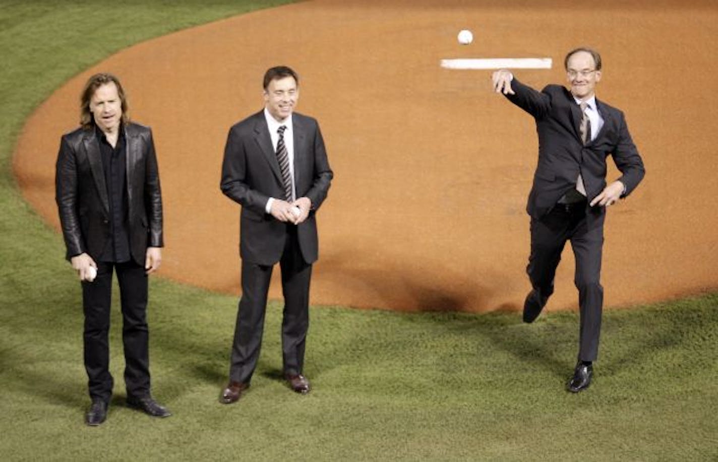 The Pohlad brothers (l to r) Bill, Bob and Jim threw out the first pitch before the start of a game at the Metrodome.