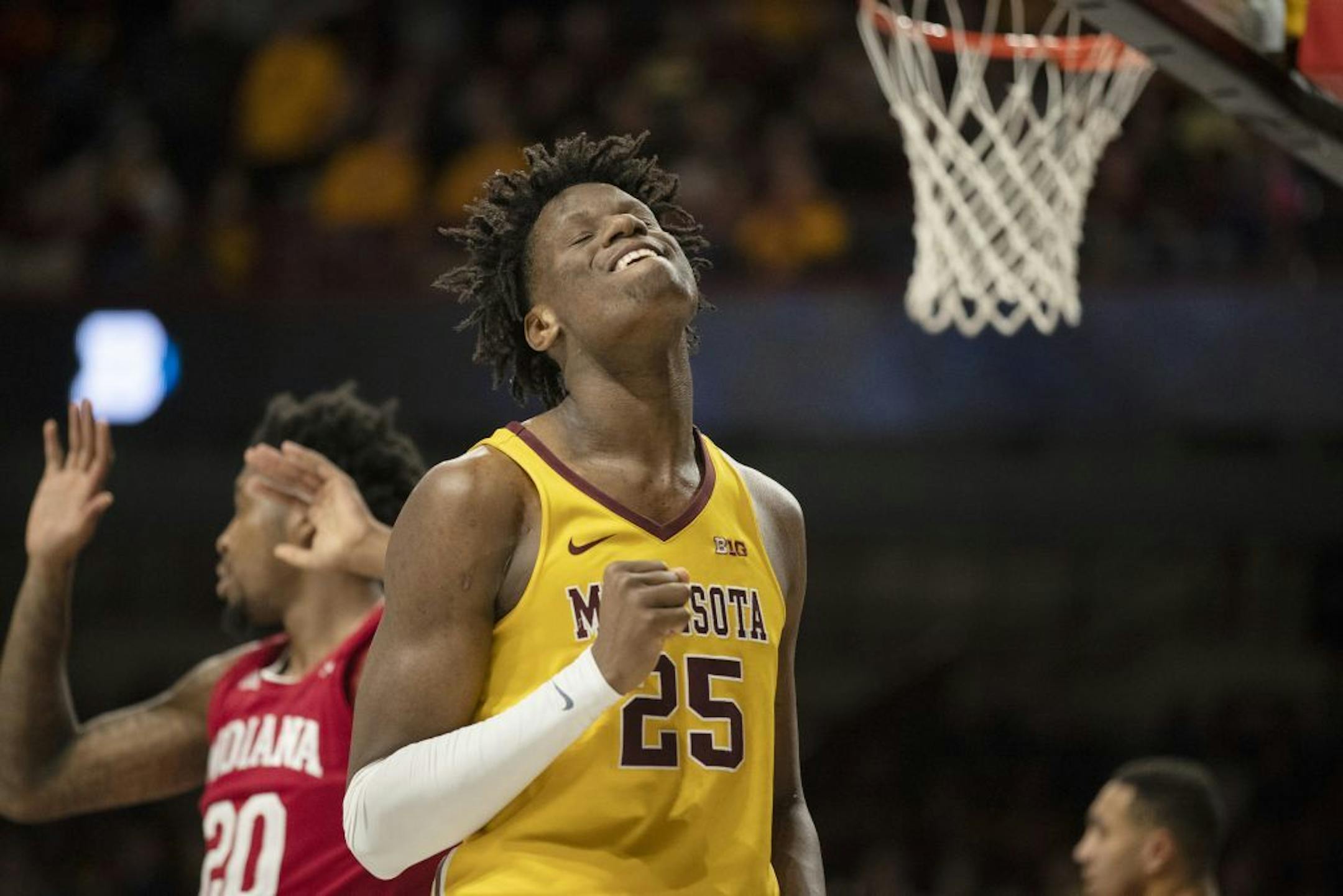 Minnesota Gophers center Daniel Oturu (25) reacts after scoring a basket in the first half .
