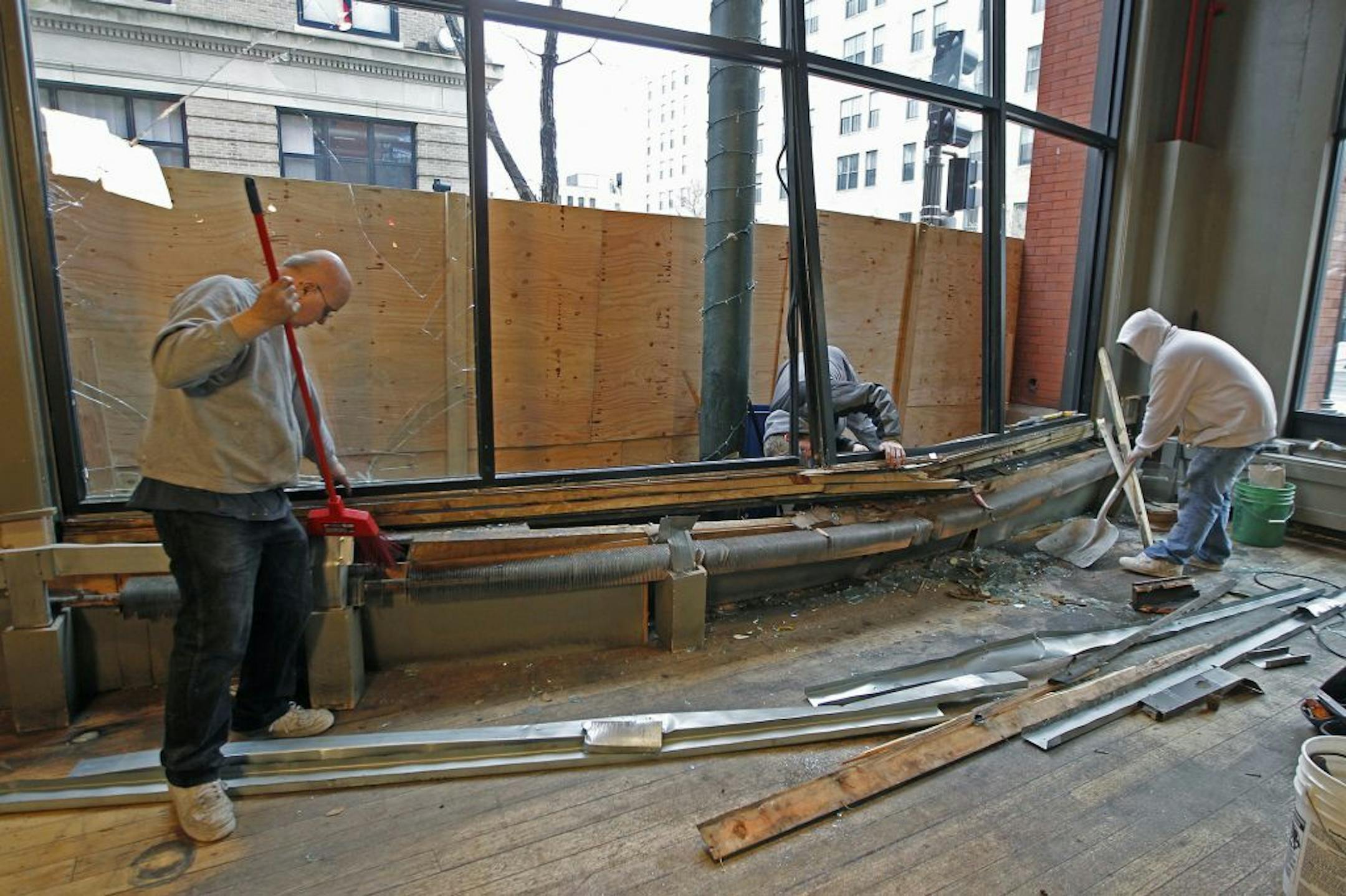 The Bulldog Lowertown's building maintenance manager Gene Klcoke, left, and his son Scotte Klocke cleaned up the scene after a car crashed through.